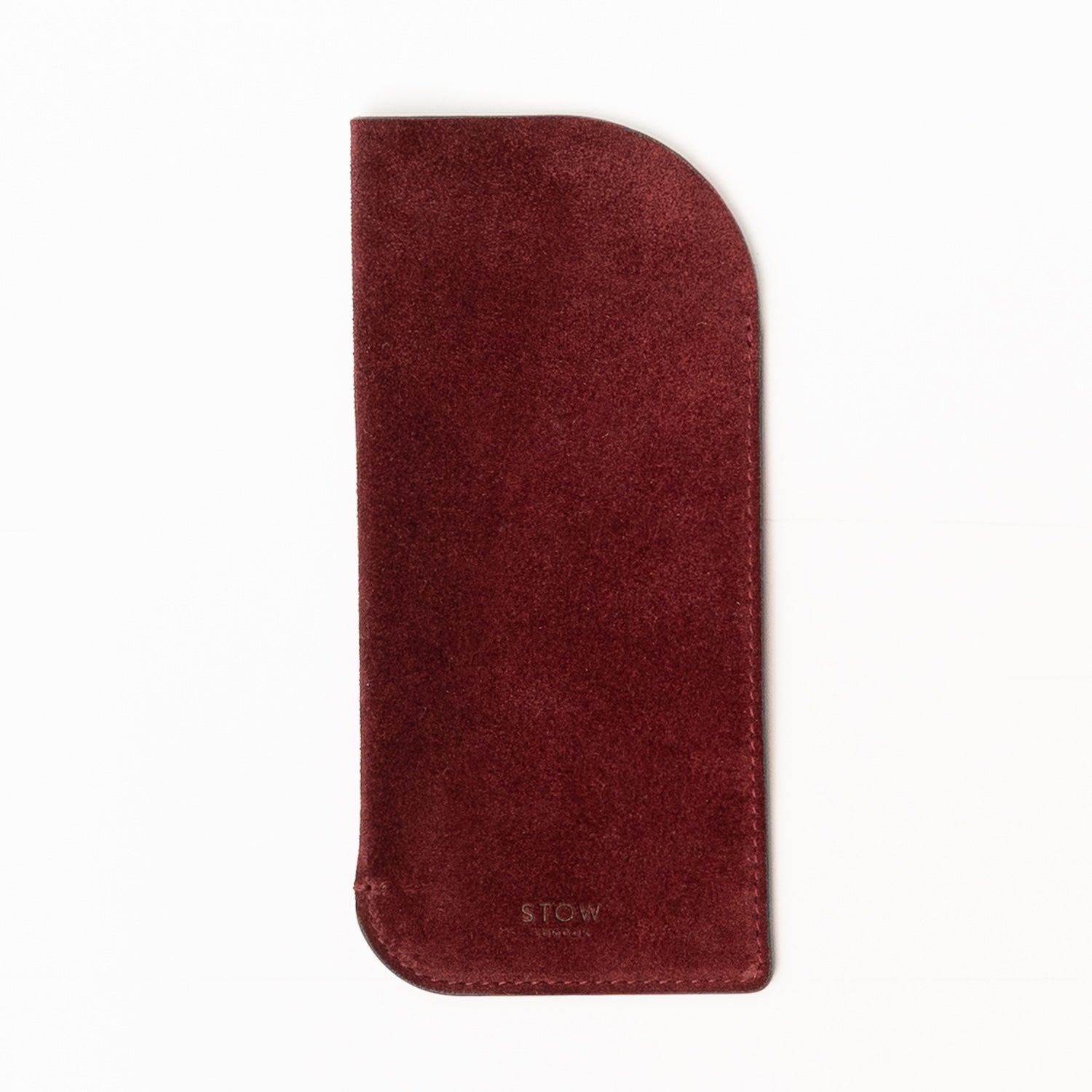 STOW London's Glasses Case in Burgundy suede leather on a light grey background featuring an embossed STOW London on front