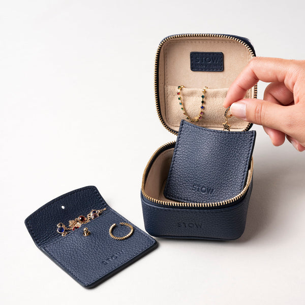 STOW Leather Hester Jewellery Case in Navy colour, open showing two leather sleeves inside (included with case) and an assortment of jewellery.