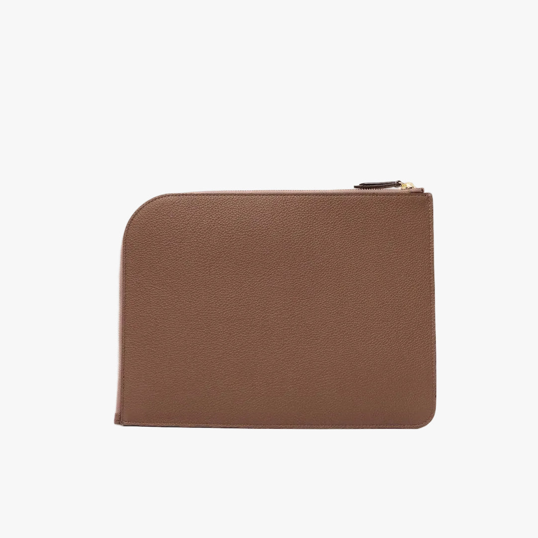 Back panel of STOW London's Ipad Sleeve in Mocha pebbled leather on a light grey background featuring a YKK Natulon Zip closure