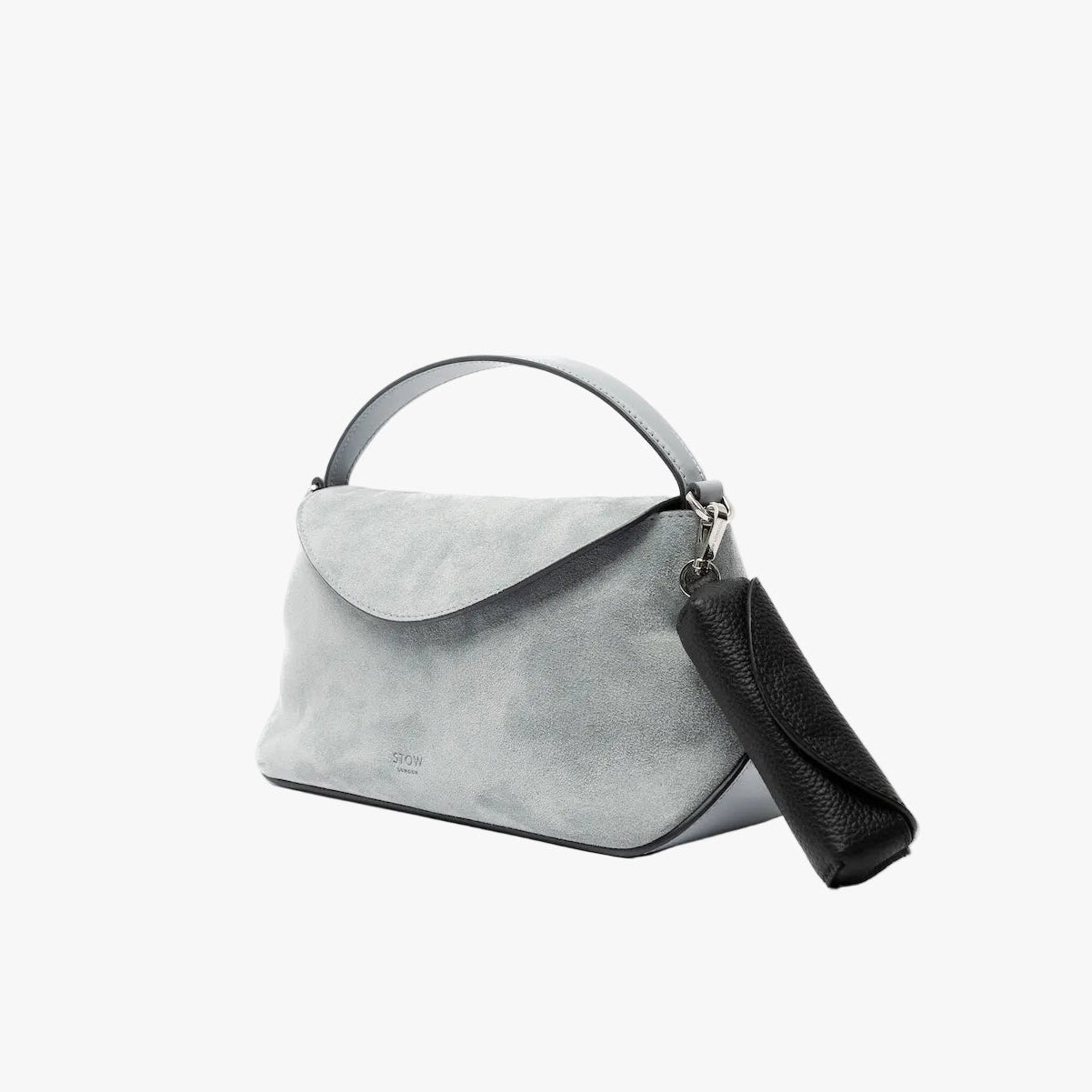 STOW London's Lipstick Case in Black pebbled leather attached to the Mini East West in Misty Blue suede featuring a silver stainless steel clip on a light grey background