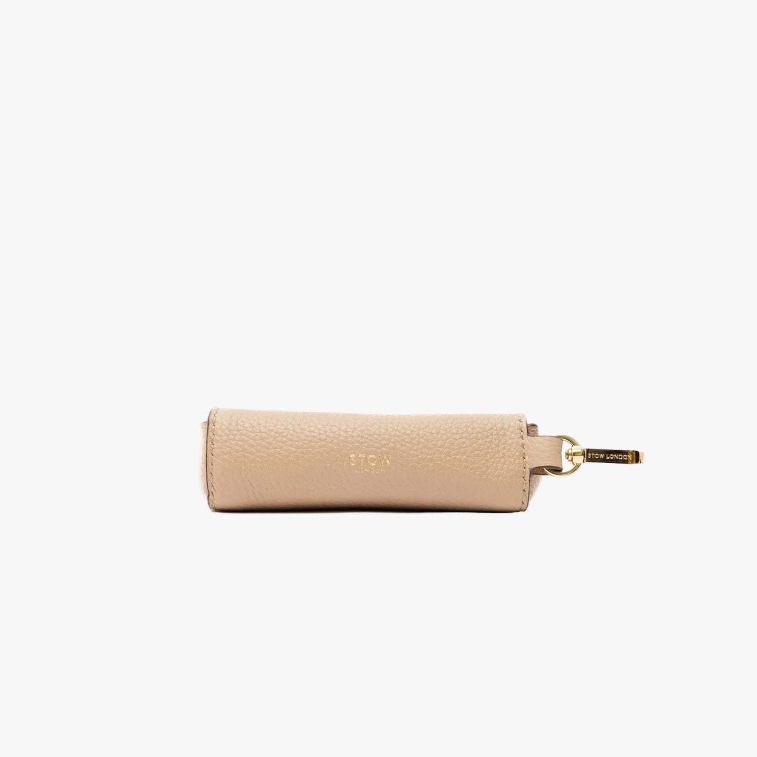 STOW London's Lipstick Case in Camel pebbled leather on a light grey background featuring gold-coated stainless steel hardware