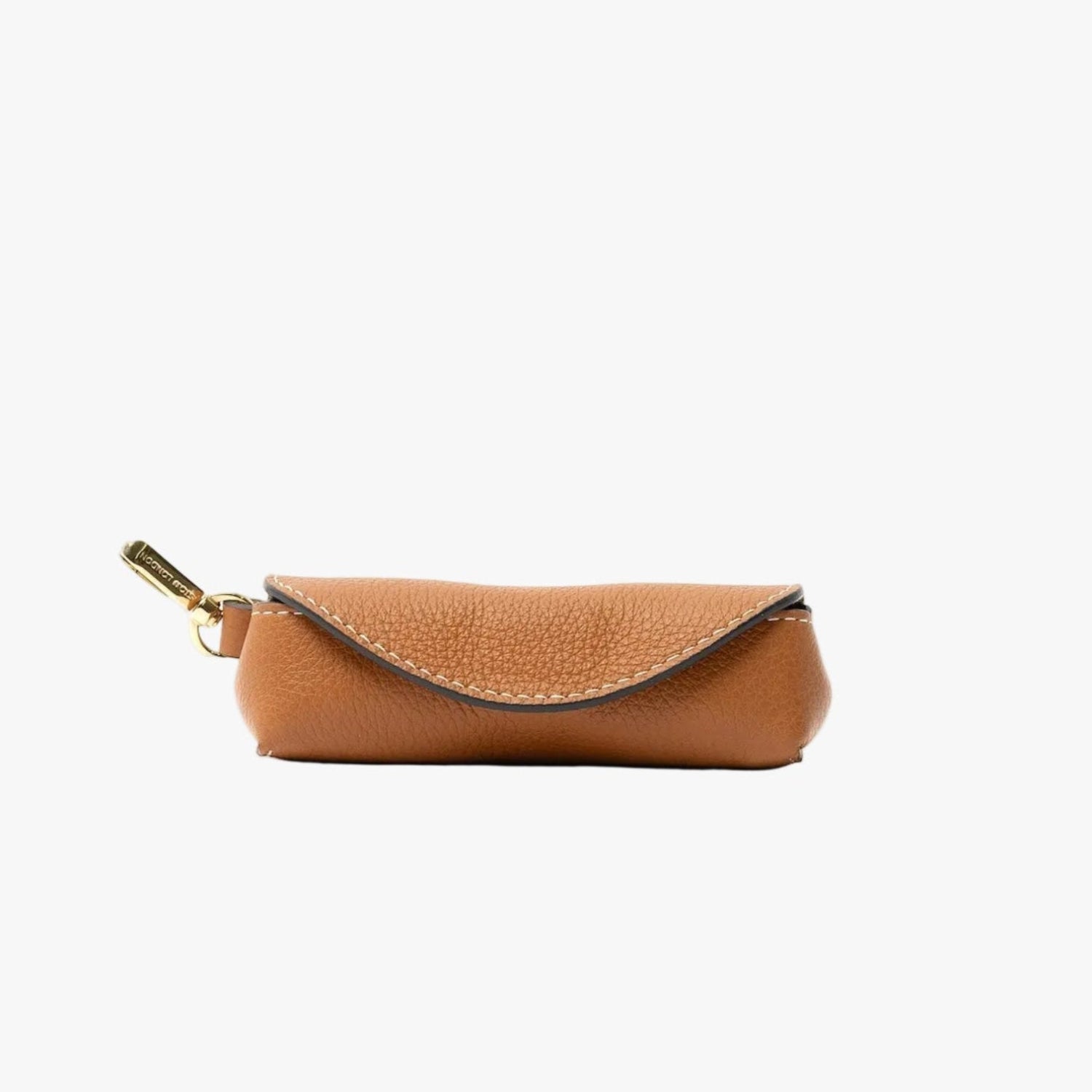 STOW London's Lipstick Case in Earth Tan pebbled leather featuring a gold-coated stainless steel clip on a light grey background