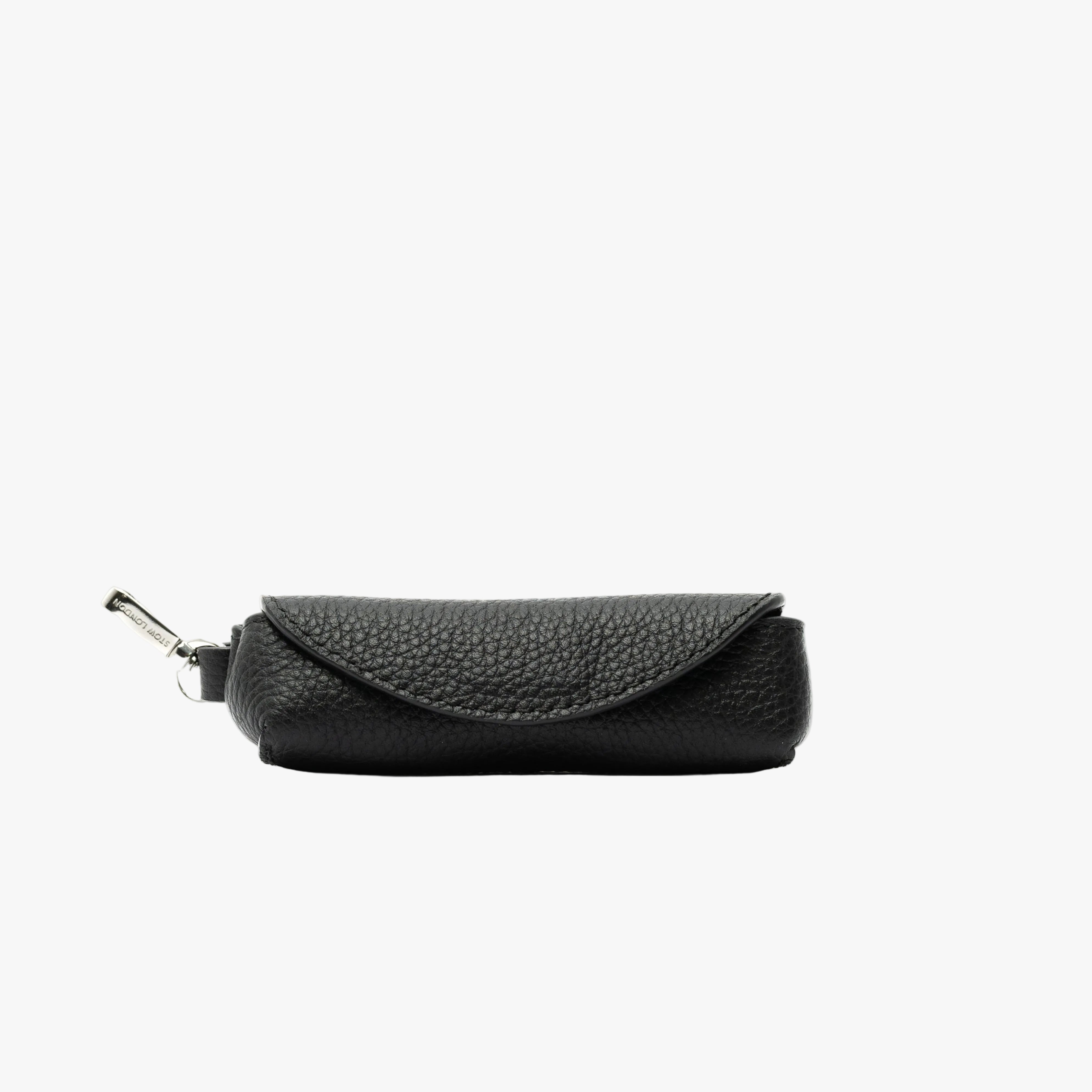 STOW London's Lipstick Case in Black pebbled leather featuring a silver stainless steel clip on a light grey background