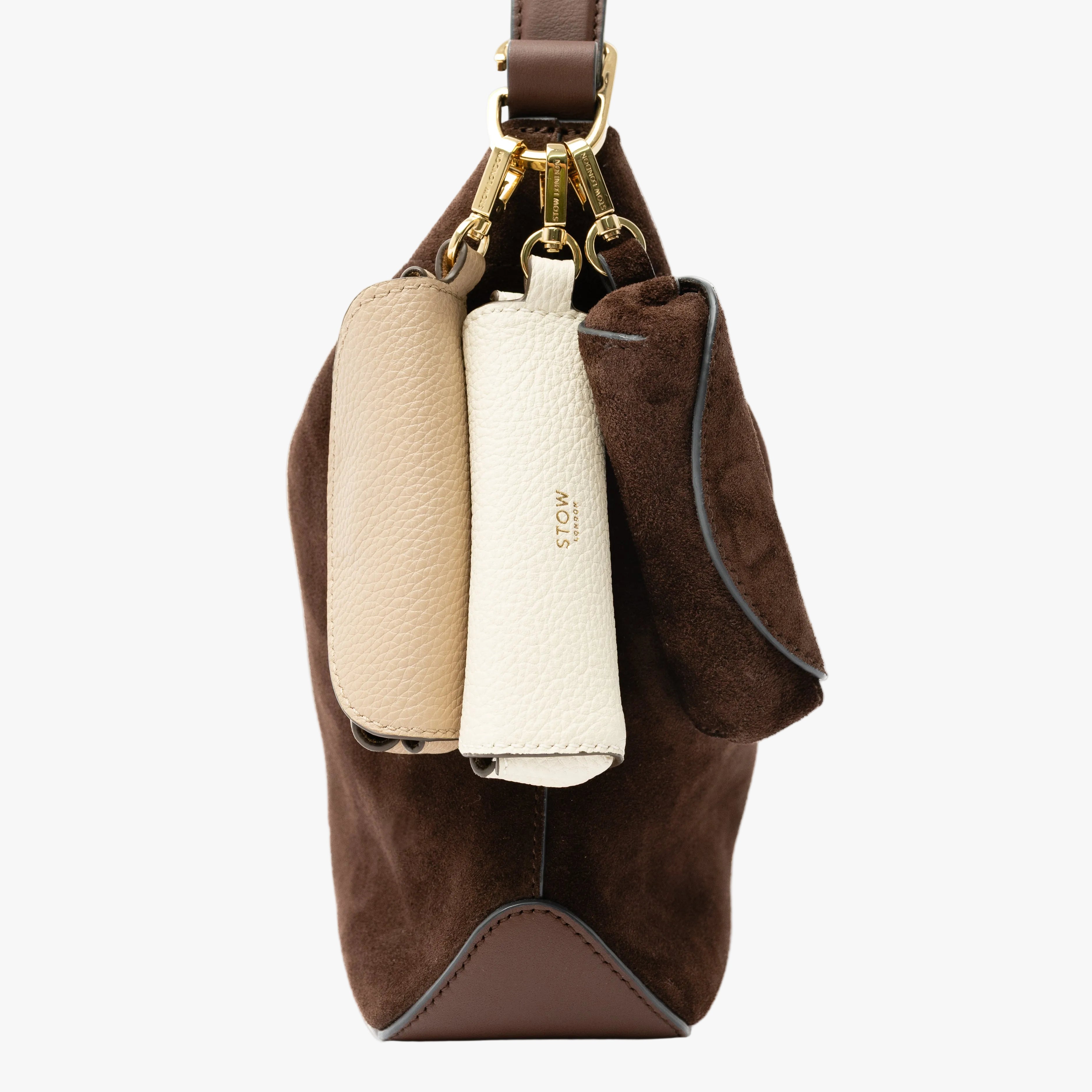 STOW London's Lipstick Cases in Chocolate Suede, Camel and Spring Moon pebbled leather attached by gold-coated stainless steel clips to the Midi Curve in Chocolate Suede on a light grey background