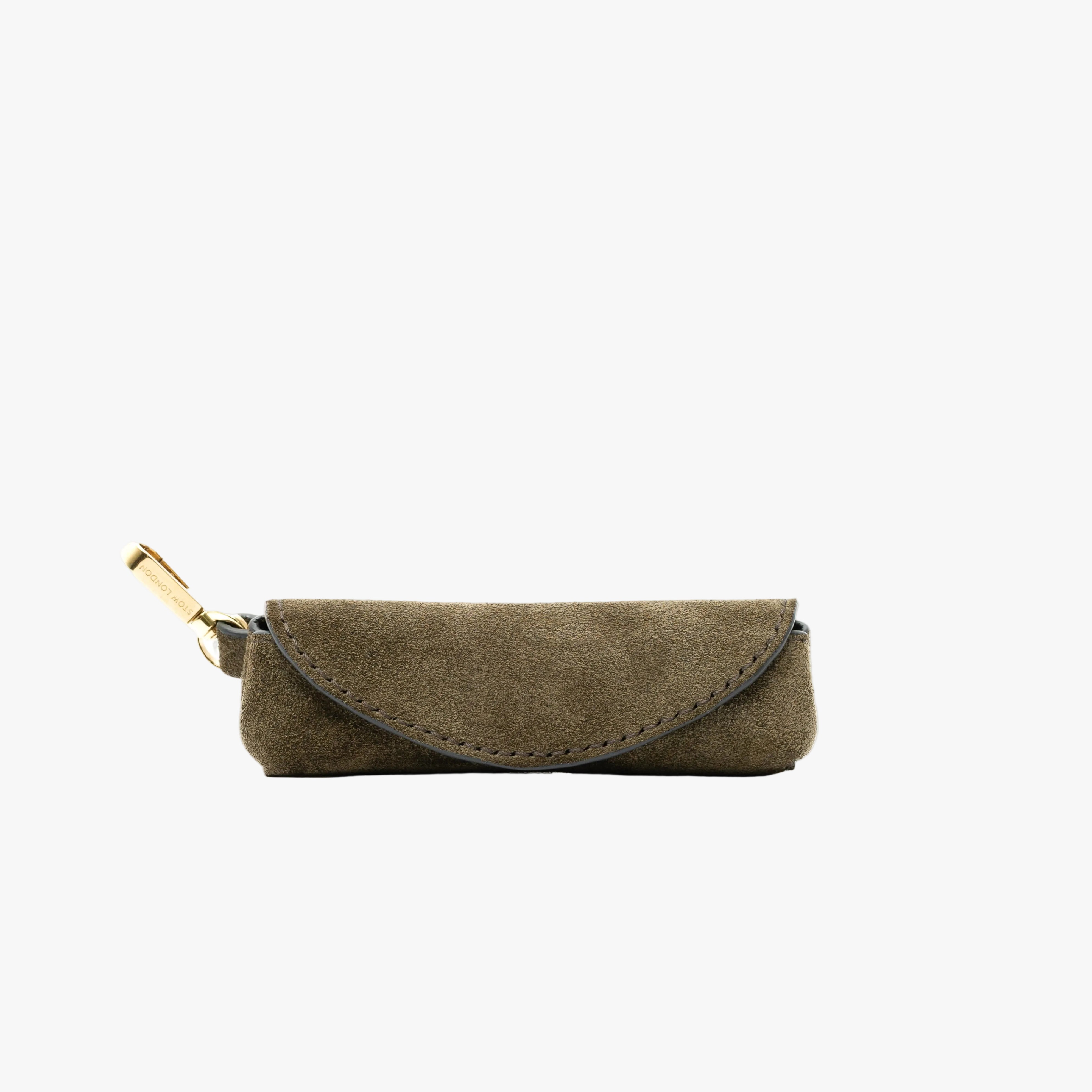 STOW London's Lipstick Case in Dark Green Suede leather featuring a gold-coated stainless steel clip on a light grey background