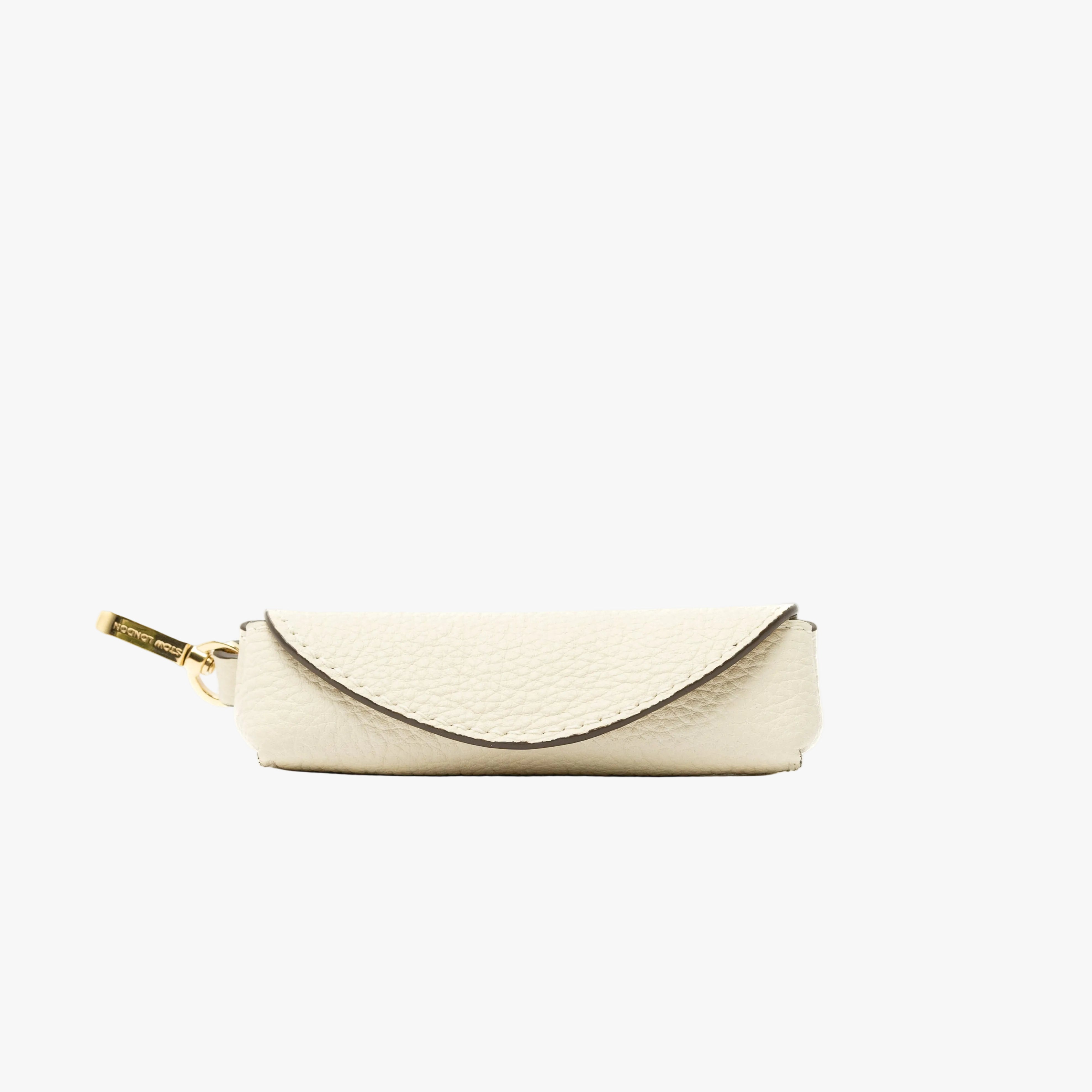 STOW London's Lipstick Case in Spring Moon pebbled leather featuring a gold-coated stainless steel clip on a light grey background