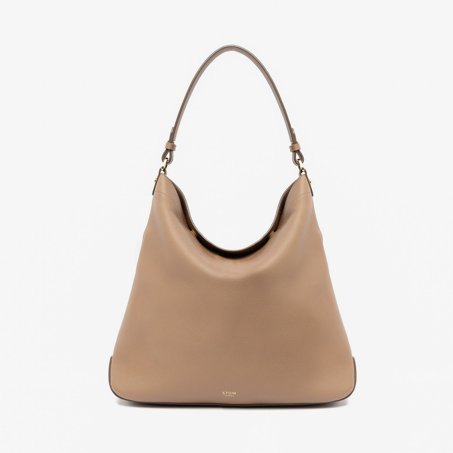STOW London's Maxi Curve bag in Mocha pebbled leather featuring gold-coated stainless steel hardware on a light grey background