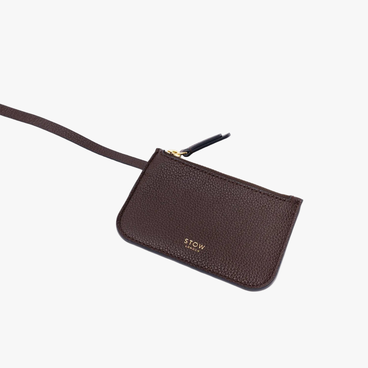 The detachable, matching pouch from STOW London's Midi Curve in Espresso pebbled leather on a light grey background featuring gold-coated stainless steel hardware