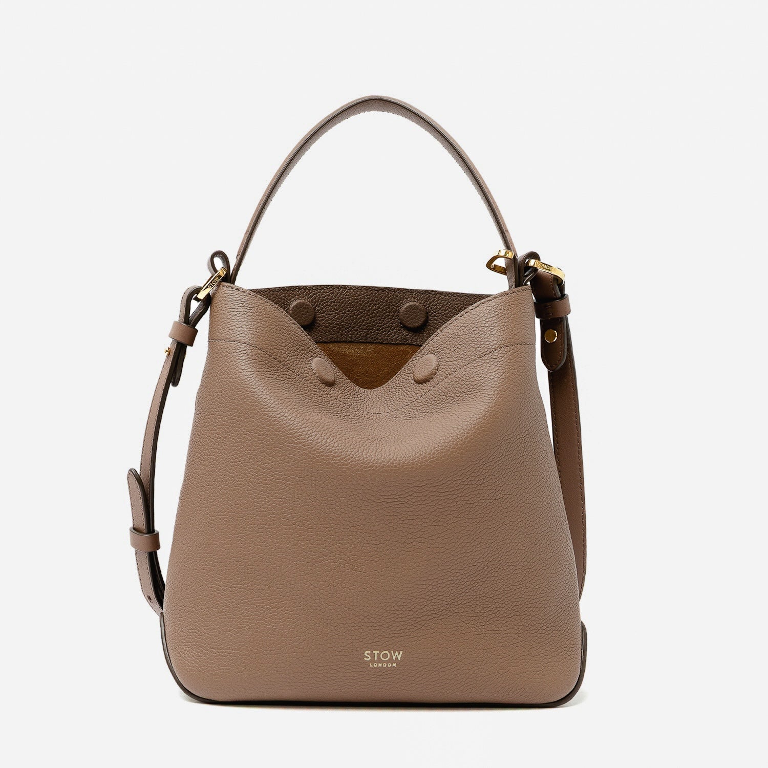 STOW London's Midi Curve in Mocha pebbled leather featuring gold-coated stainless steel hardware on a light grey background