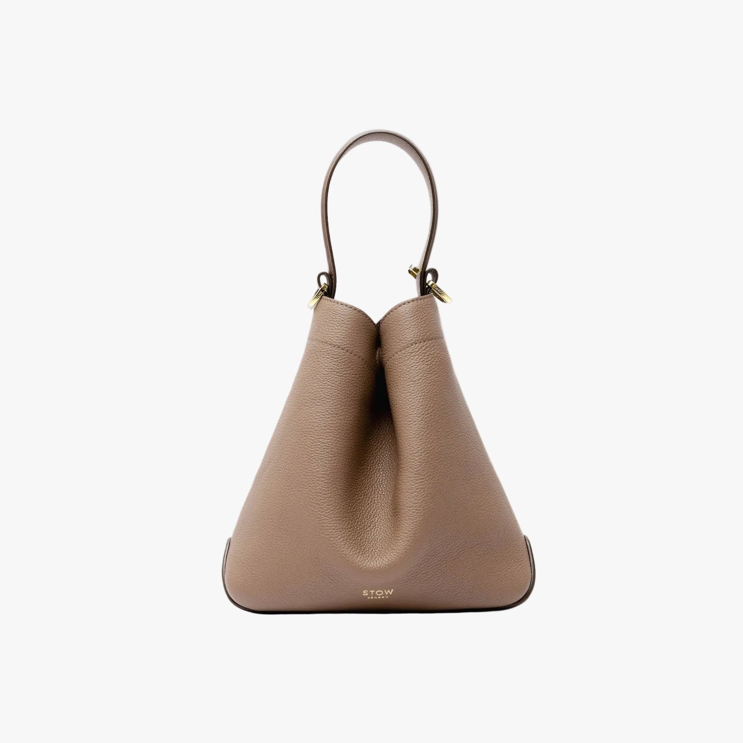 STOW London's Midi Curve bag in Mocha pebbled leather styled in its triangular form featuring gold-coated stainless steel hardware on a light grey background