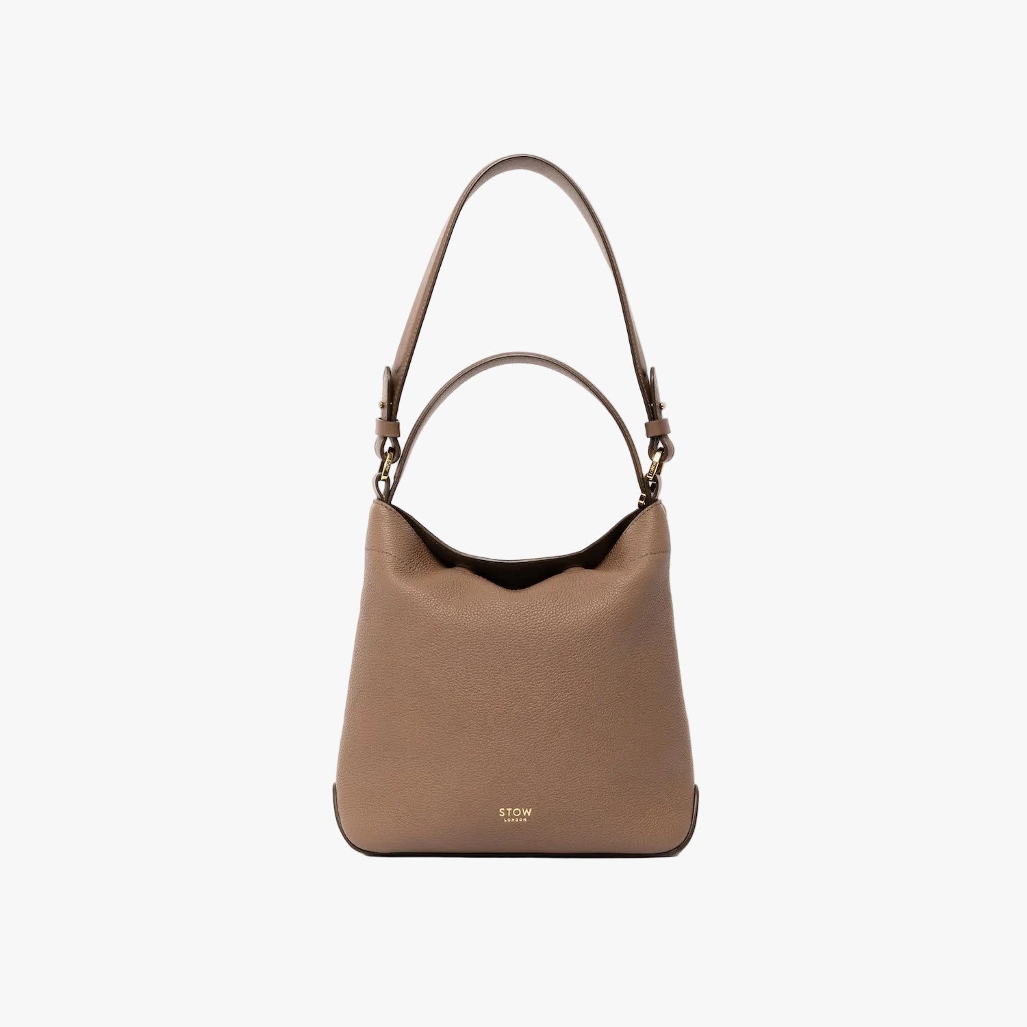 STOW London's Midi Curve and detachable shoulder strap in Mocha leather on a light grey background with top handle out featuring gold hardware and details