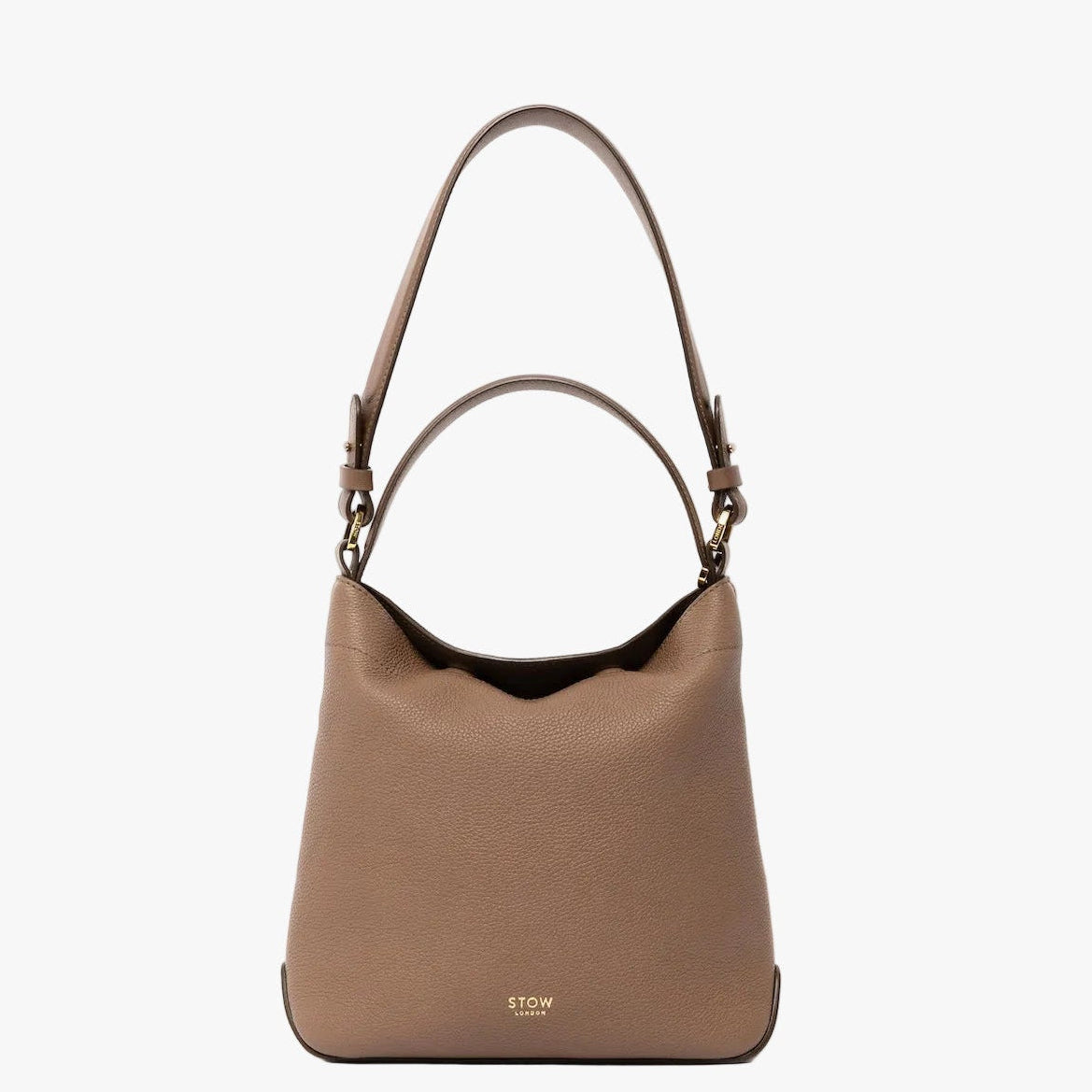 STOW London's Midi Curve and detachable shoulder strap in Mocha leather on a light grey background with top handle out featuring gold hardware and details