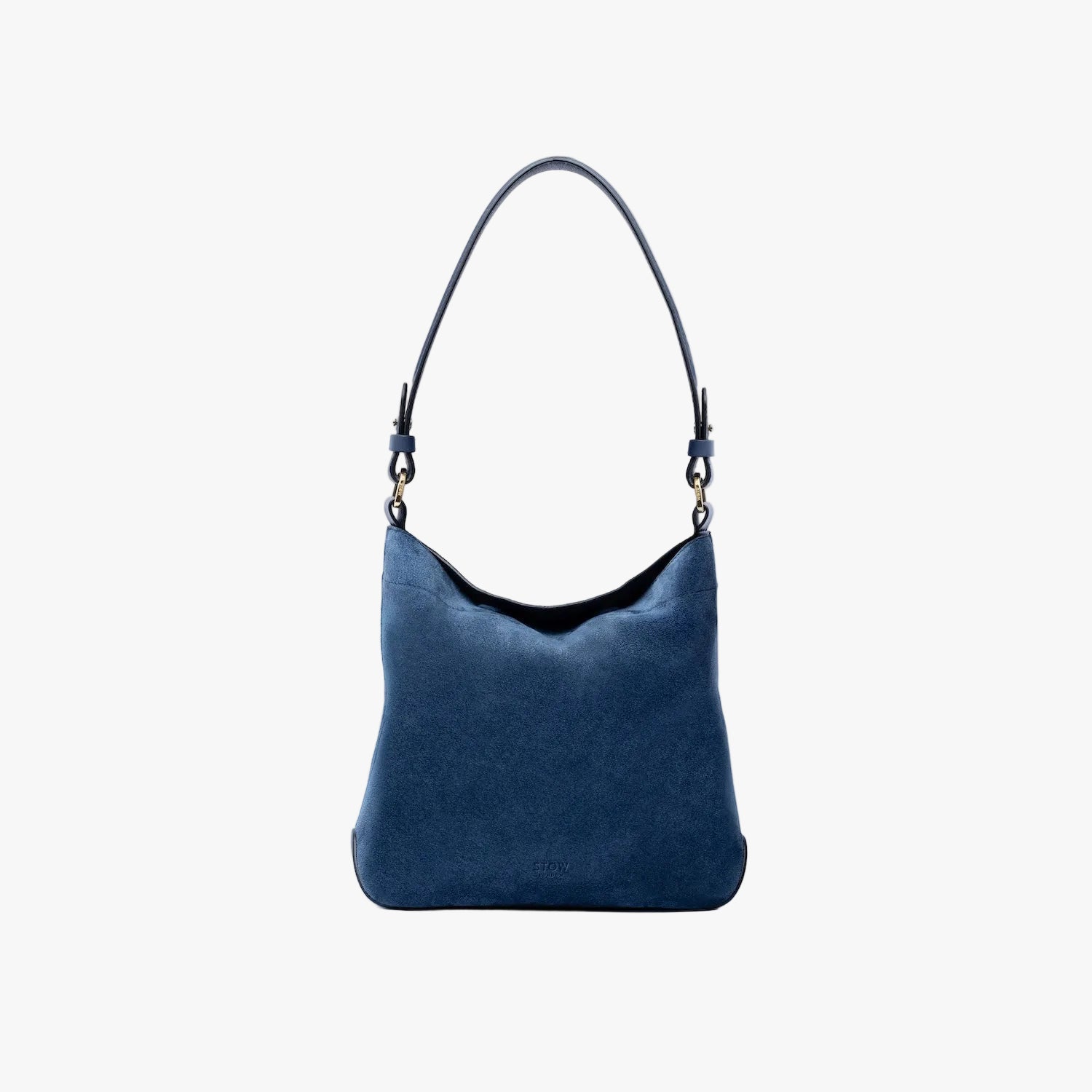 STOW London's Midi Curve in Navy suede leather on a light grey background featuring the detachable shoulder strap with gold hardware and details