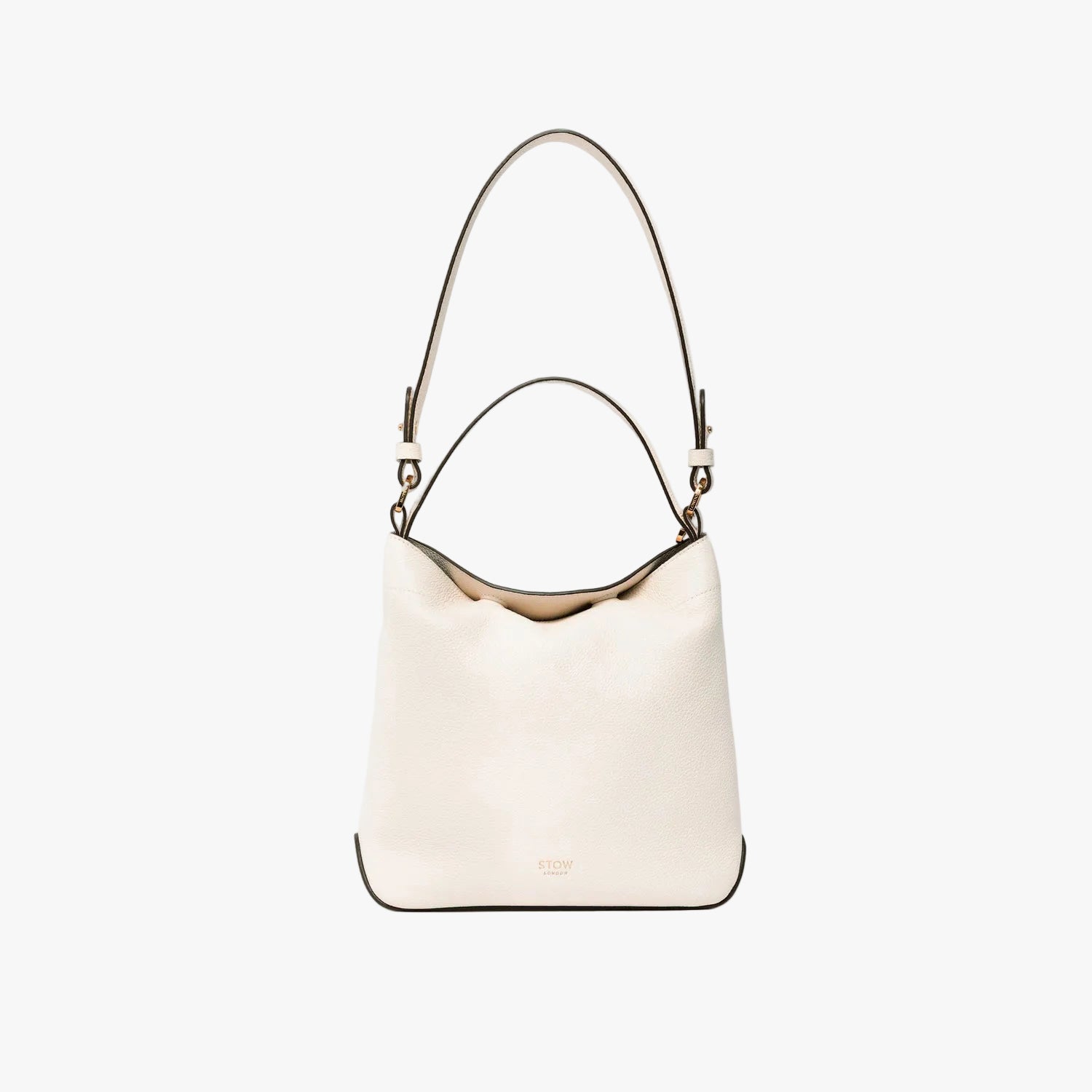 STOW London's Midi Curve in Spring Moon leather on a light grey background featuring the detachable shoulder strap with gold hardware and details