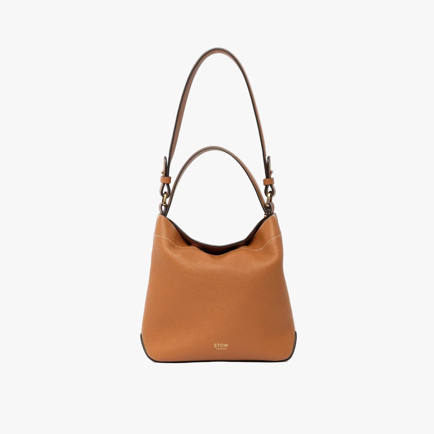 STOW London's Midi Curve in Earth Tan leather with the detachable shoulder strap with top handle out on a light grey background featuring gold details