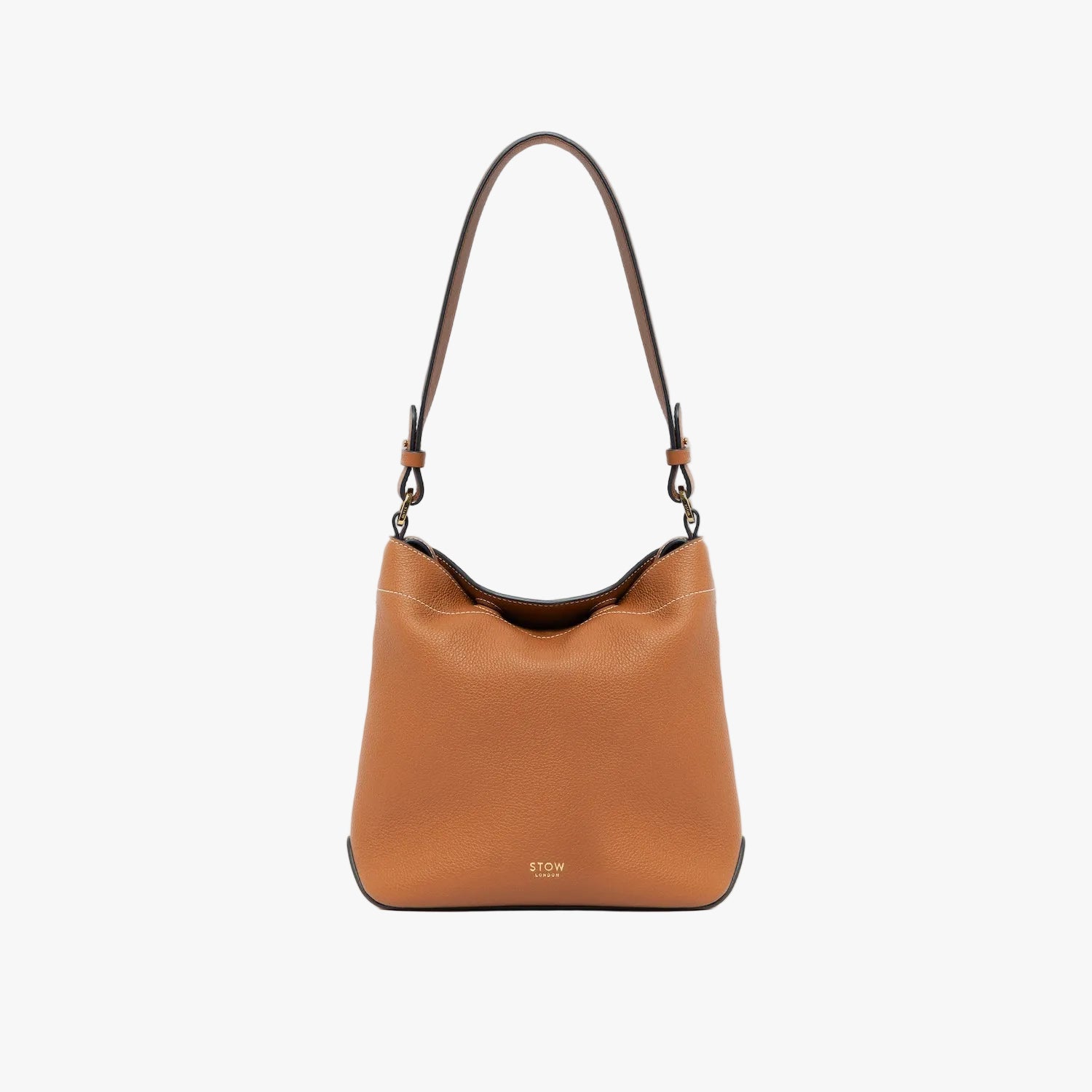 STOW London's Midi Curve in Earth Tan leather with the detachable shoulder strap on a light grey background featuring gold details