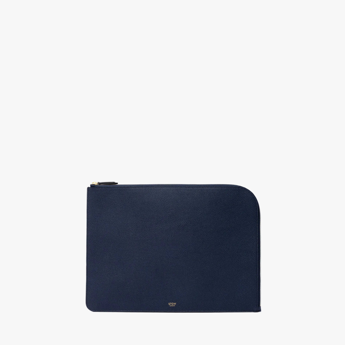 STOW London's Midi Leather Sleeve in Navy pebbled leather on a light grey background featuring a YKK Natulon Zip and a fine gold embossed logo on the front bottom.