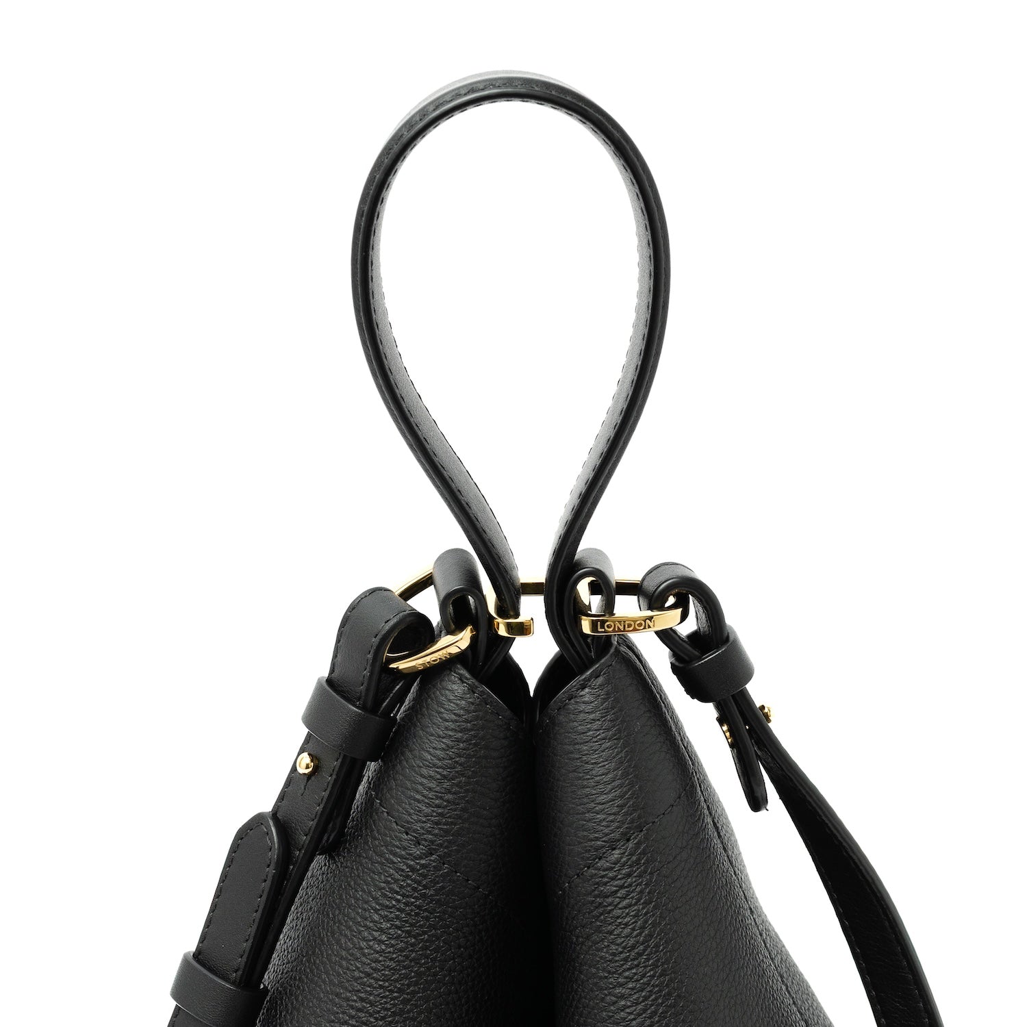 Close up of top handle, clip and detachable strap of STOW London's Midi Curve bag in Black pebbled and smooth leather featuring gold-coated stainless steel hardware on a white background