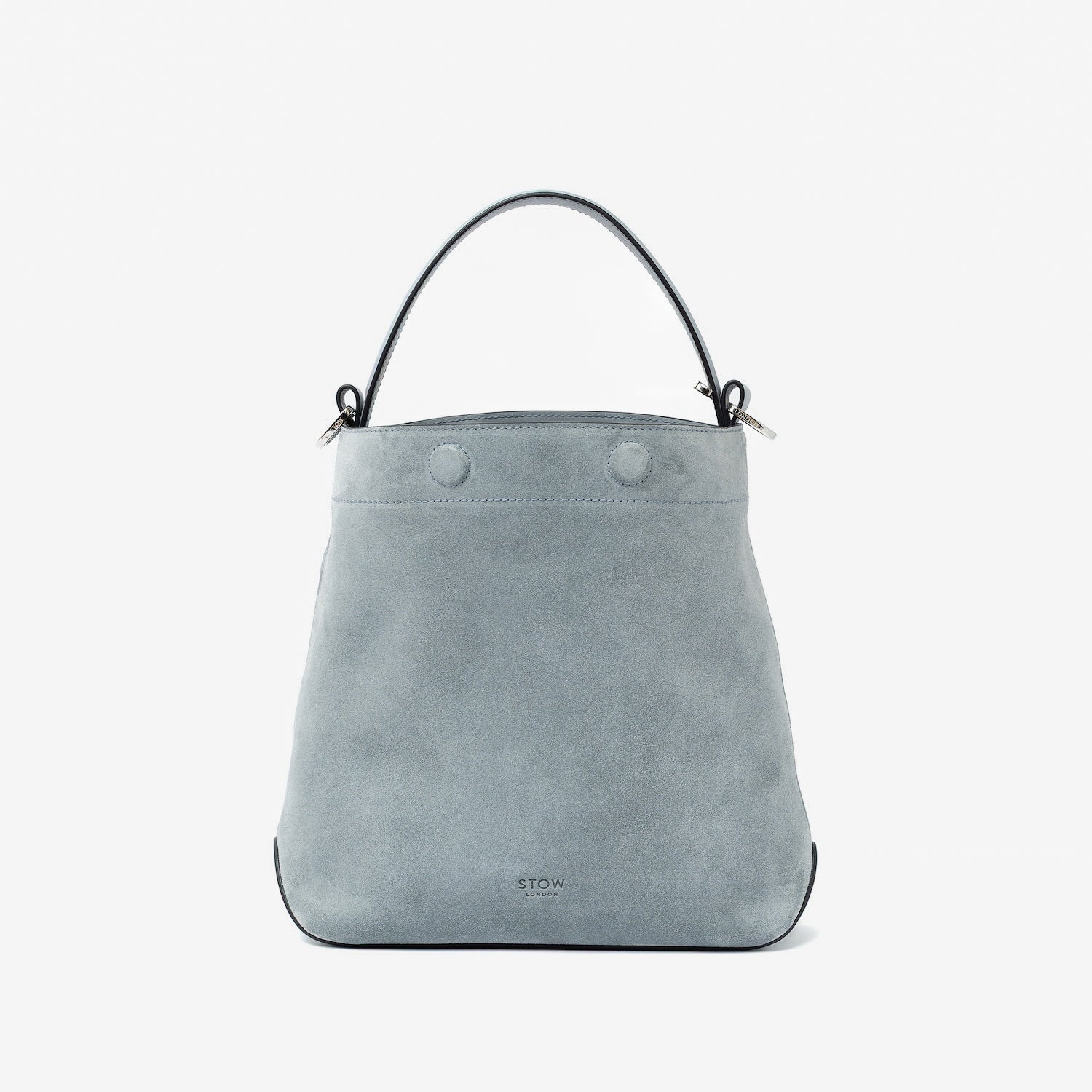 STOW London's Midi Curve in Misty Blue suede leather with magnets open styled as a bucket bag featuring silver stainless steel hardware on a light grey background