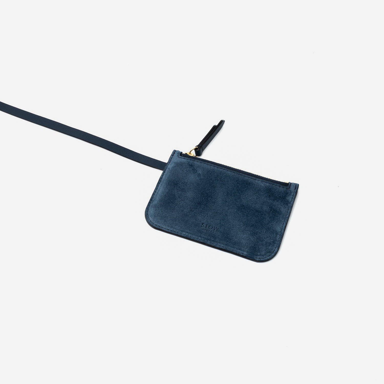 Close up of the detachable interior pouch of STOW London's Midi Curve in Navy suede leather on a light grey background
