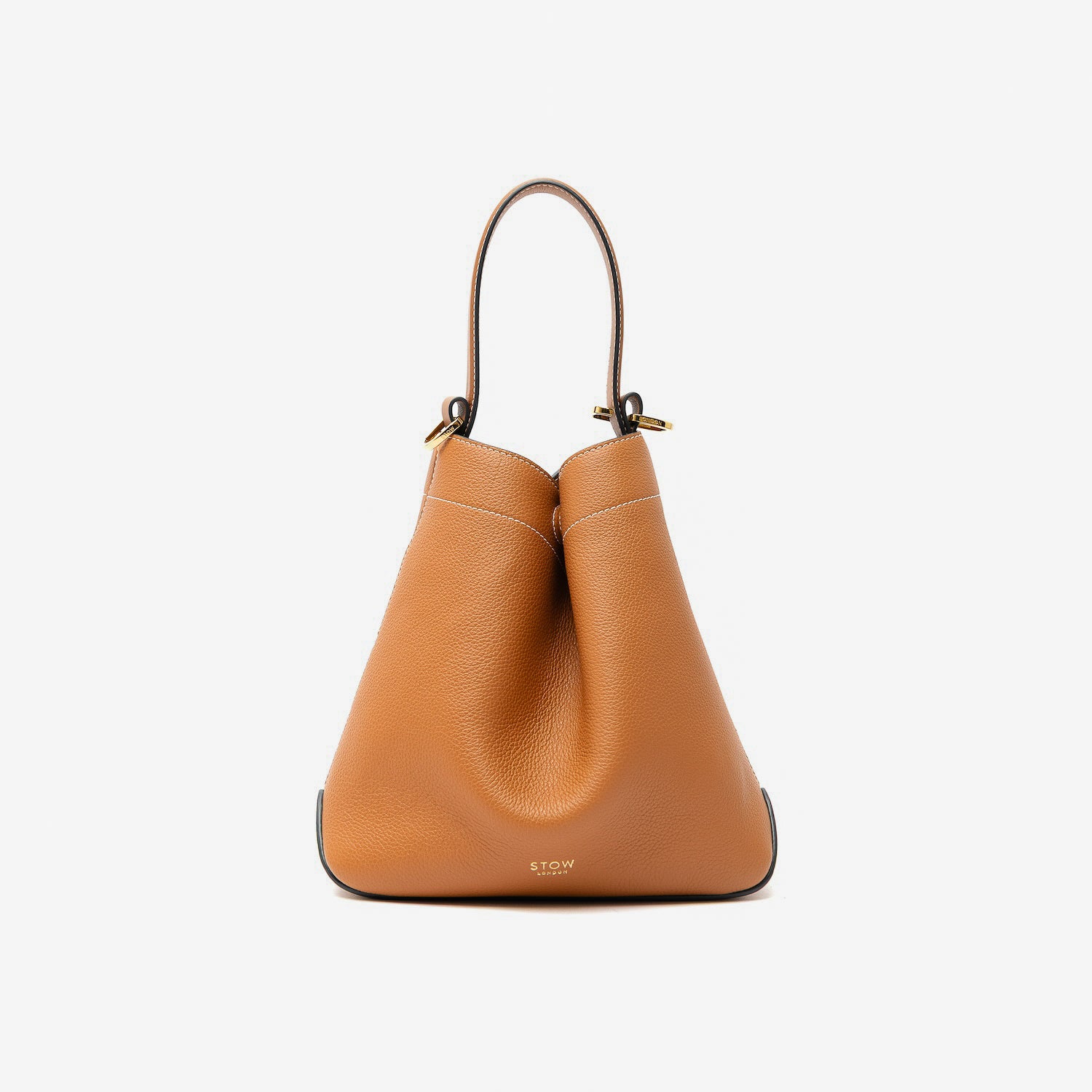 STOW London's Midi Curve in Earth Tan pebbled leather styled in a triangular shape featuring gold-coated stainless steel hardware on a light grey background