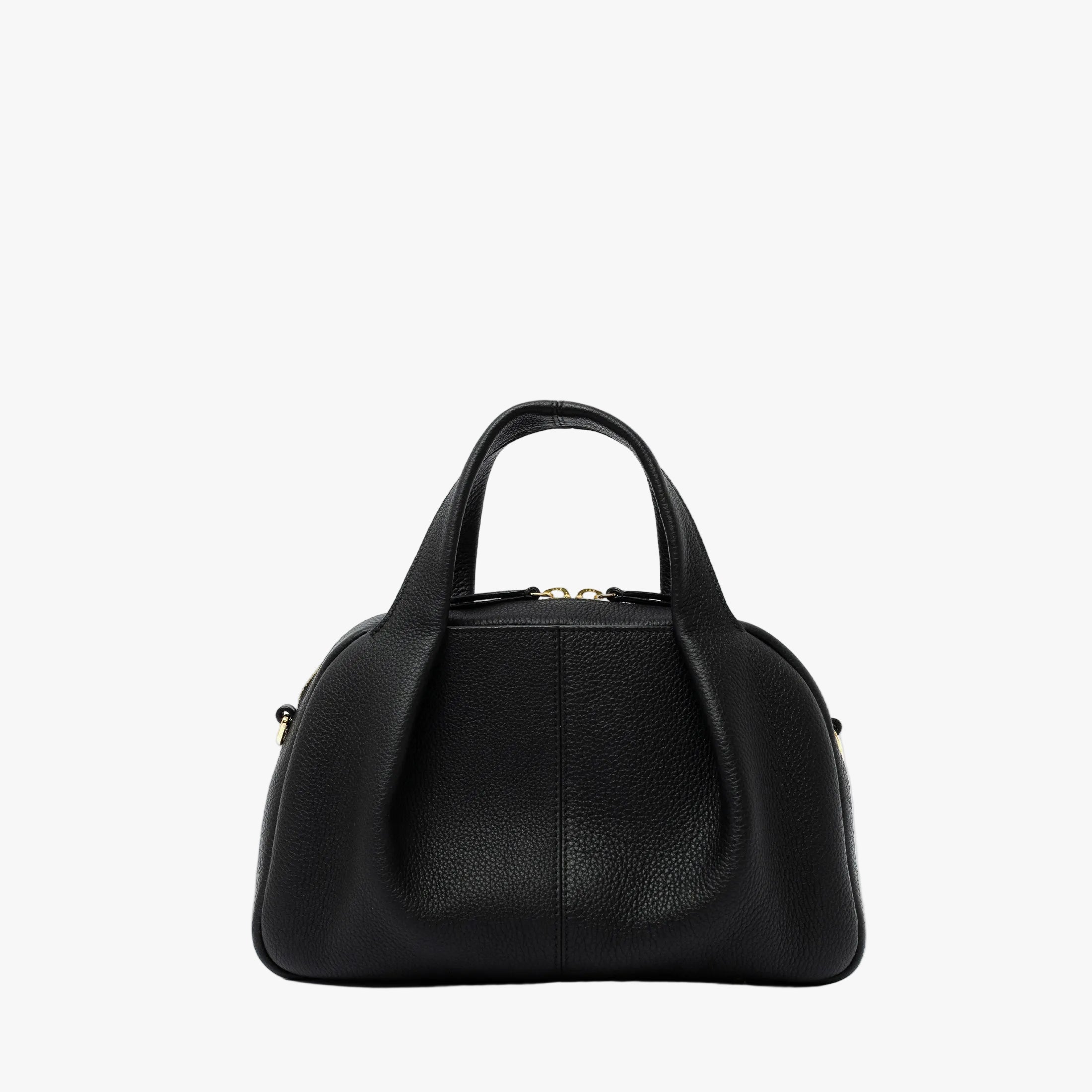 STOW London's Mini Bowling bag in Black pebbled leather featuring a pleated front panel and gold-coated stainless steel hardware on a light grey background