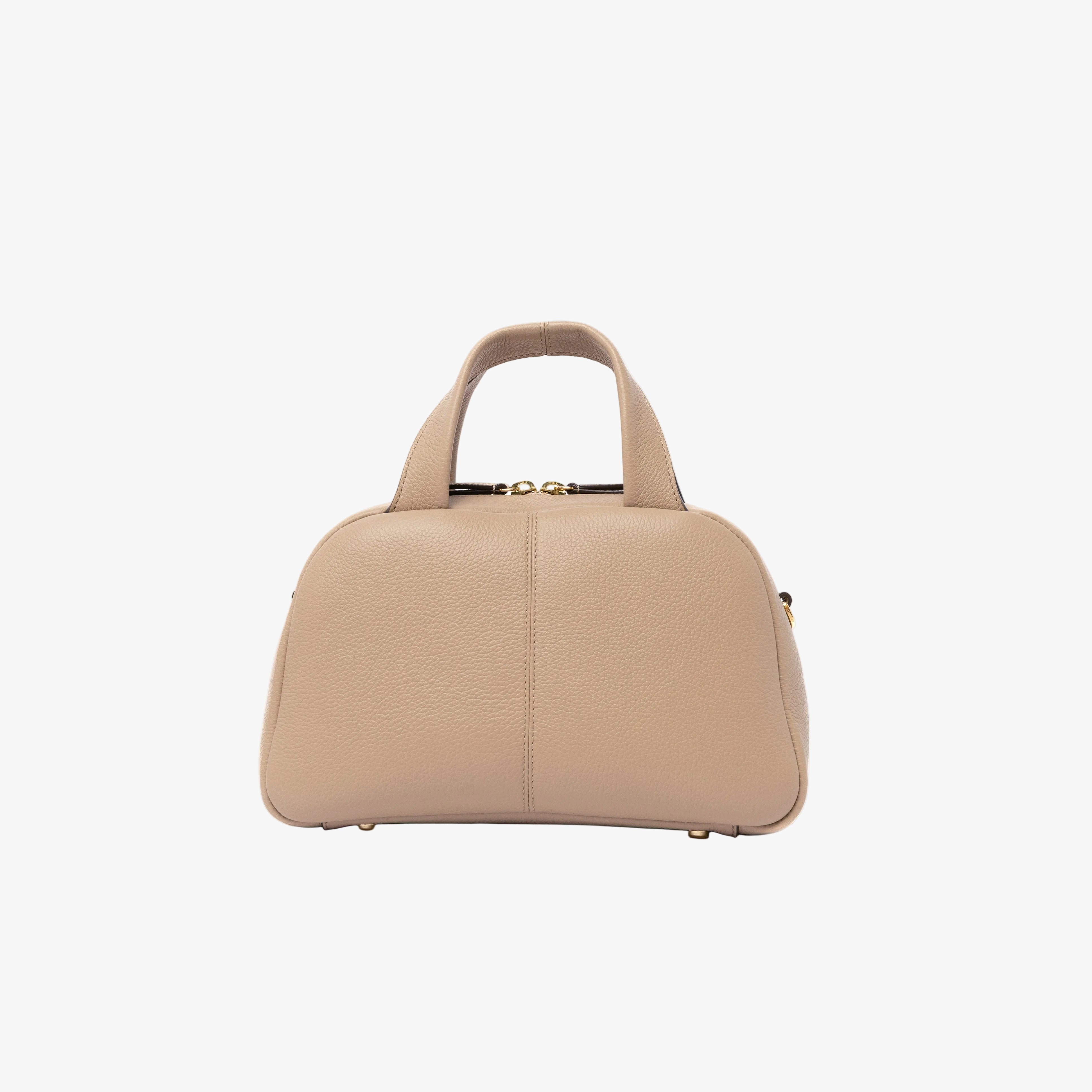Back panel of STOW London's Mini Bowling in Camel pebbled leather on a light grey background