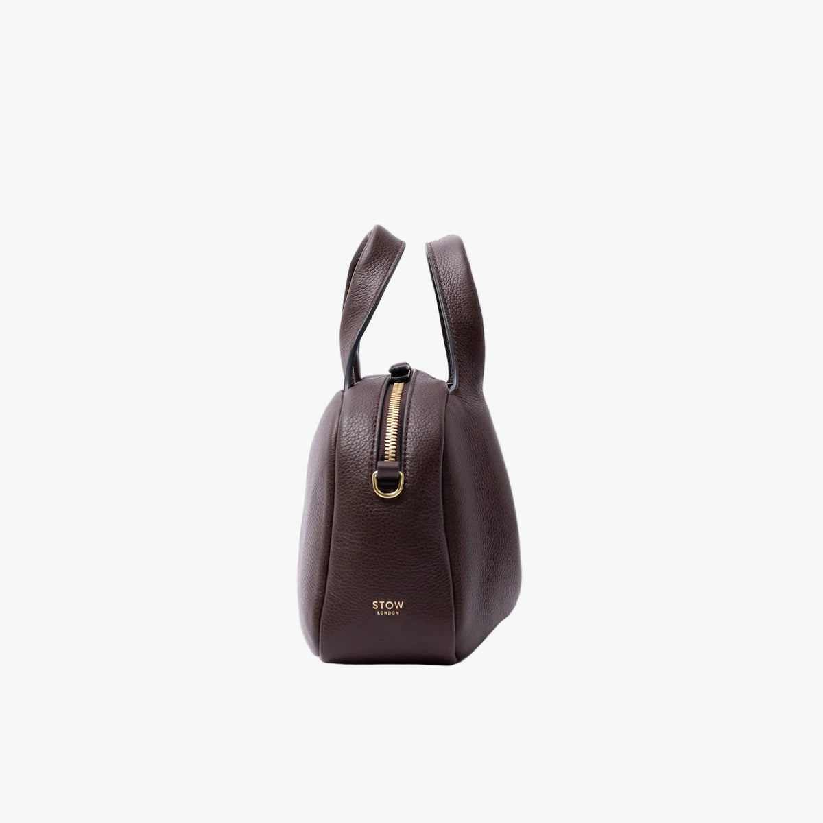 Side view of STOW London's Mini Bowling in Espresso pebbled leather on a light grey background featuring gold-coated stainless steel hardware and small embossed logo