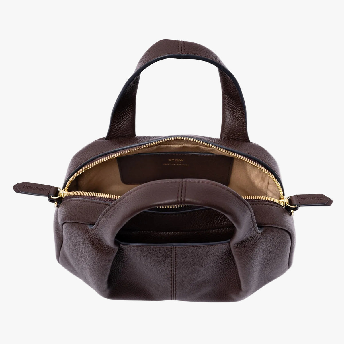 Top view of STOW London's Mini Bowling in Espresso pebbled leather on a light grey background with zipper open showing the cotton interior and leather slip pocket