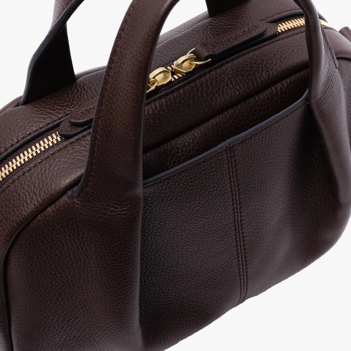 Close up of STOW London's Mini Bowling in Espresso pebbled leather on a light grey background featuring a pleated front panel, gold zip closure and external slip pocket
