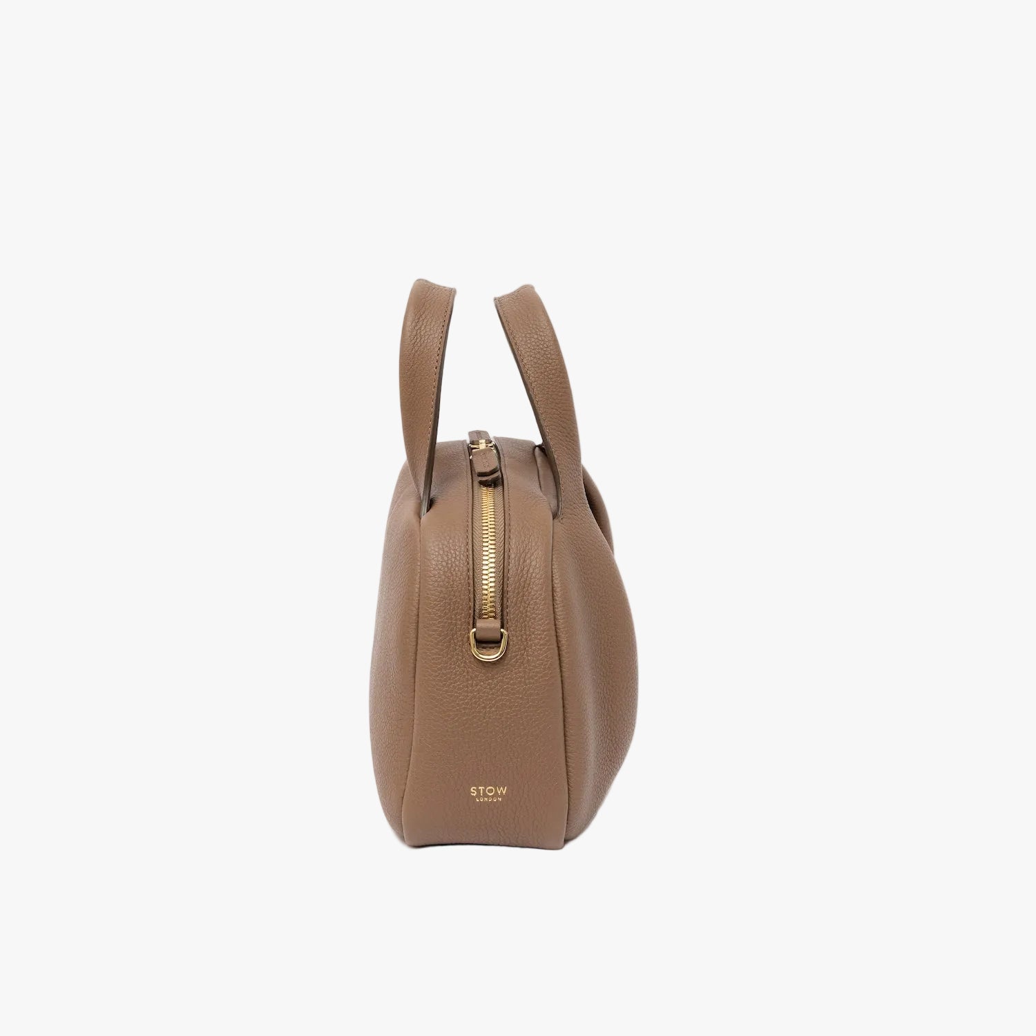 Side view of STOW London's Mini Bowling in Mocha pebbled leather featuring gold-coated stainless steel hardware and embossed logo on a light grey background