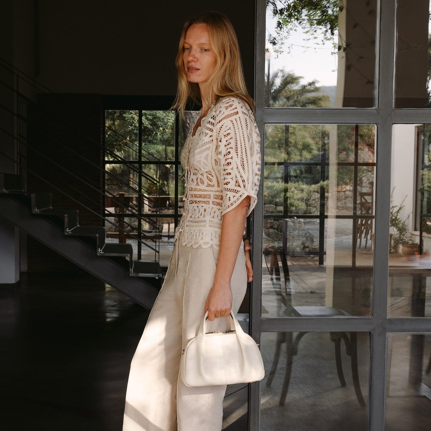 Model with STOW London's Midi Bowling in Spring Moon pebbled leather featuring gold-coated stainless steel hardware