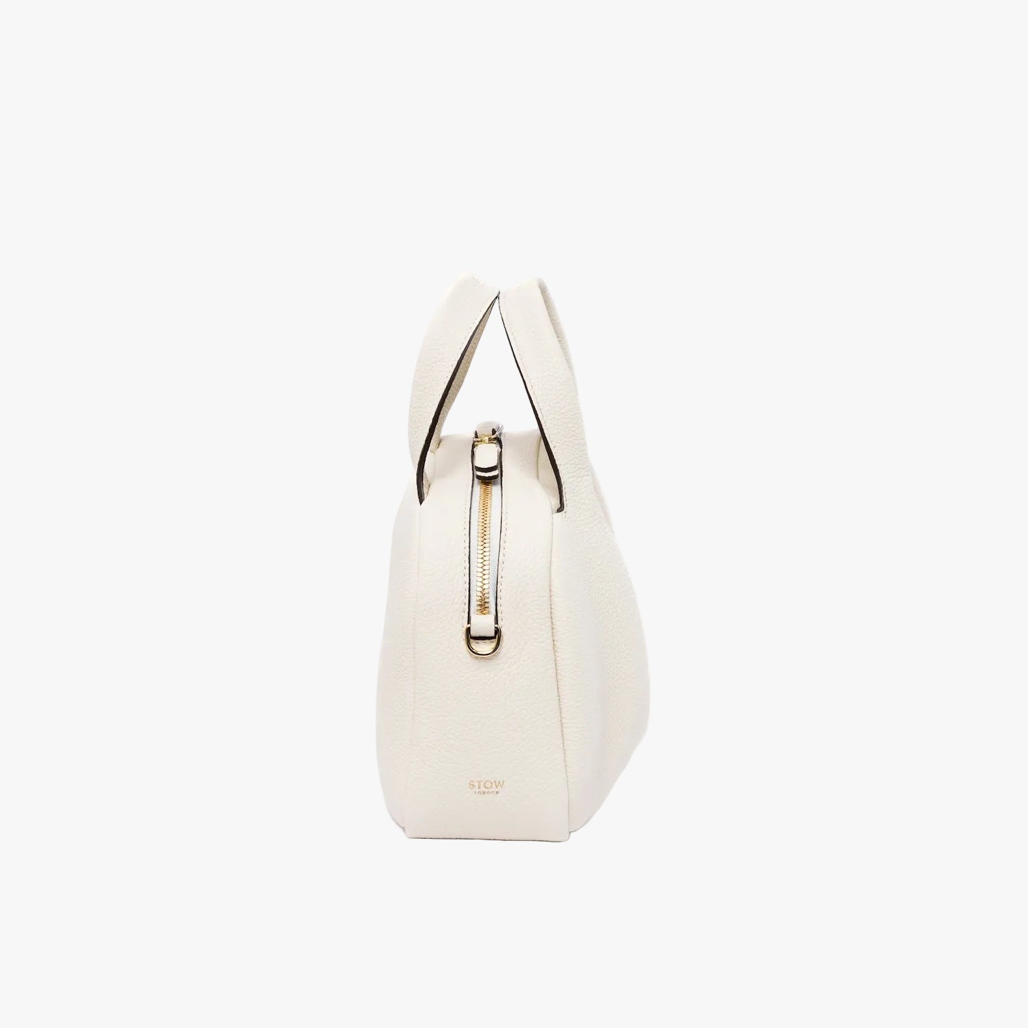 Side view of STOW London's Mini Bowling bag in Spring Moon pebbled leather featuring gold-coated stainless steel hardware on a light grey background