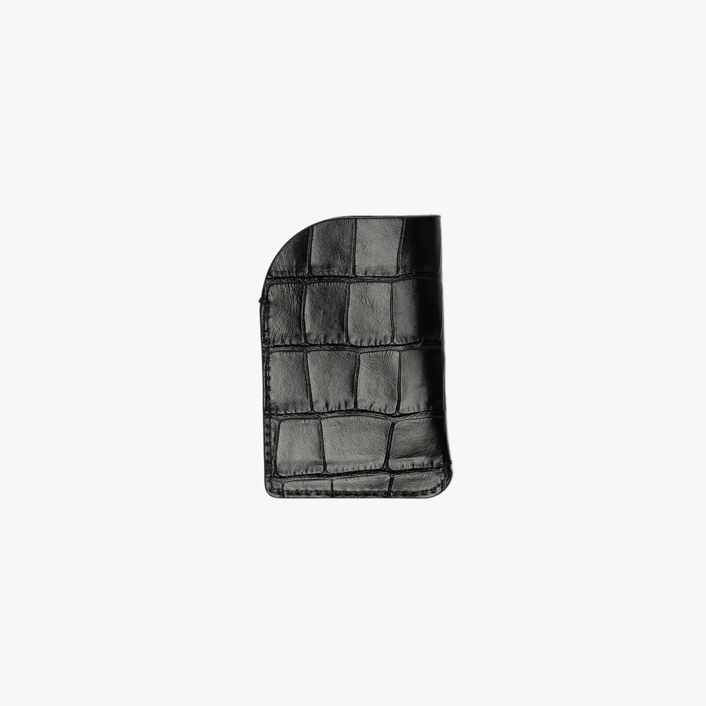Back panel of STOW London's Mini Cardholder in Black Embossed Croc leather on a light grey background