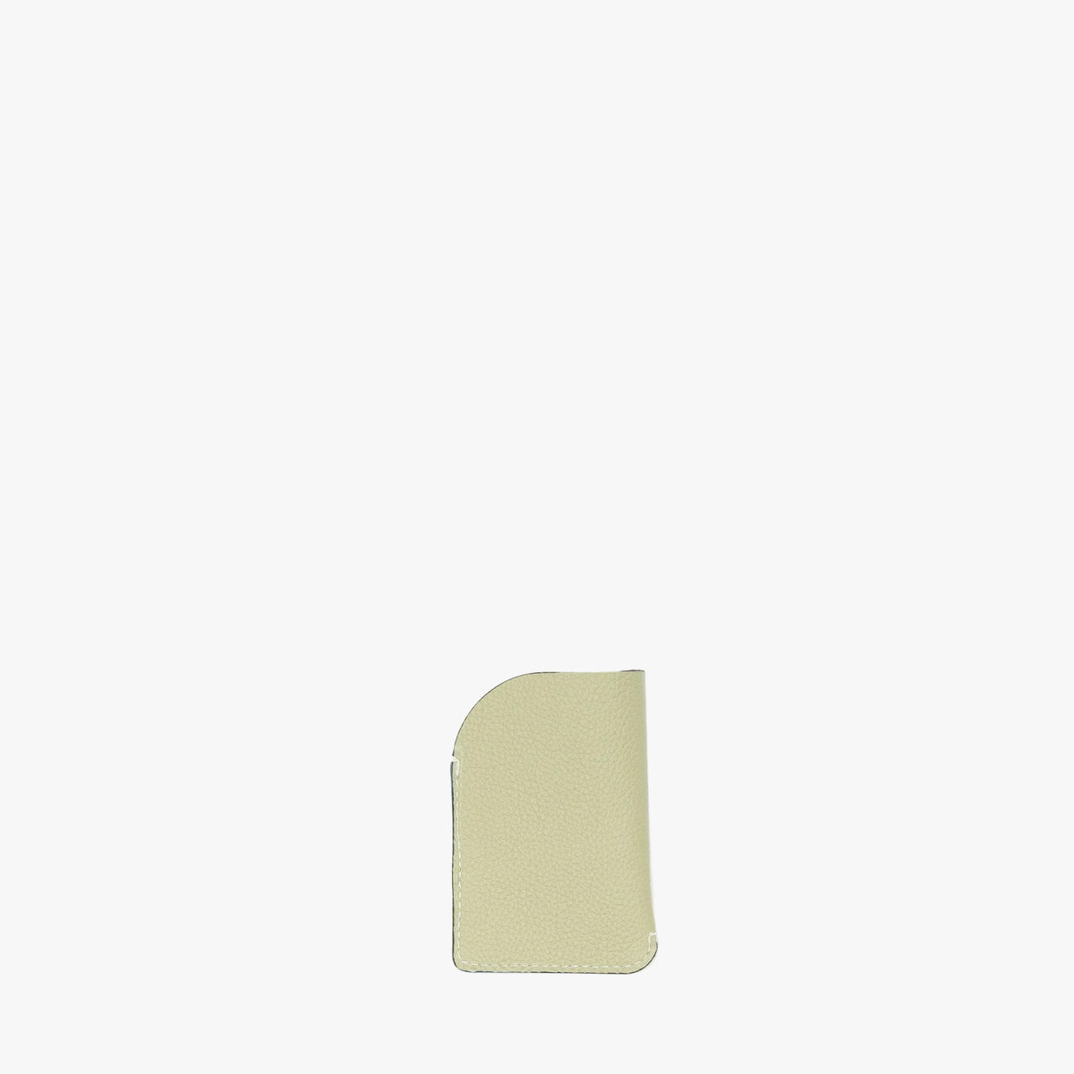 Back panel of STOW London's Mini Cardholder in Pale Green pebbled leather on a light grey background