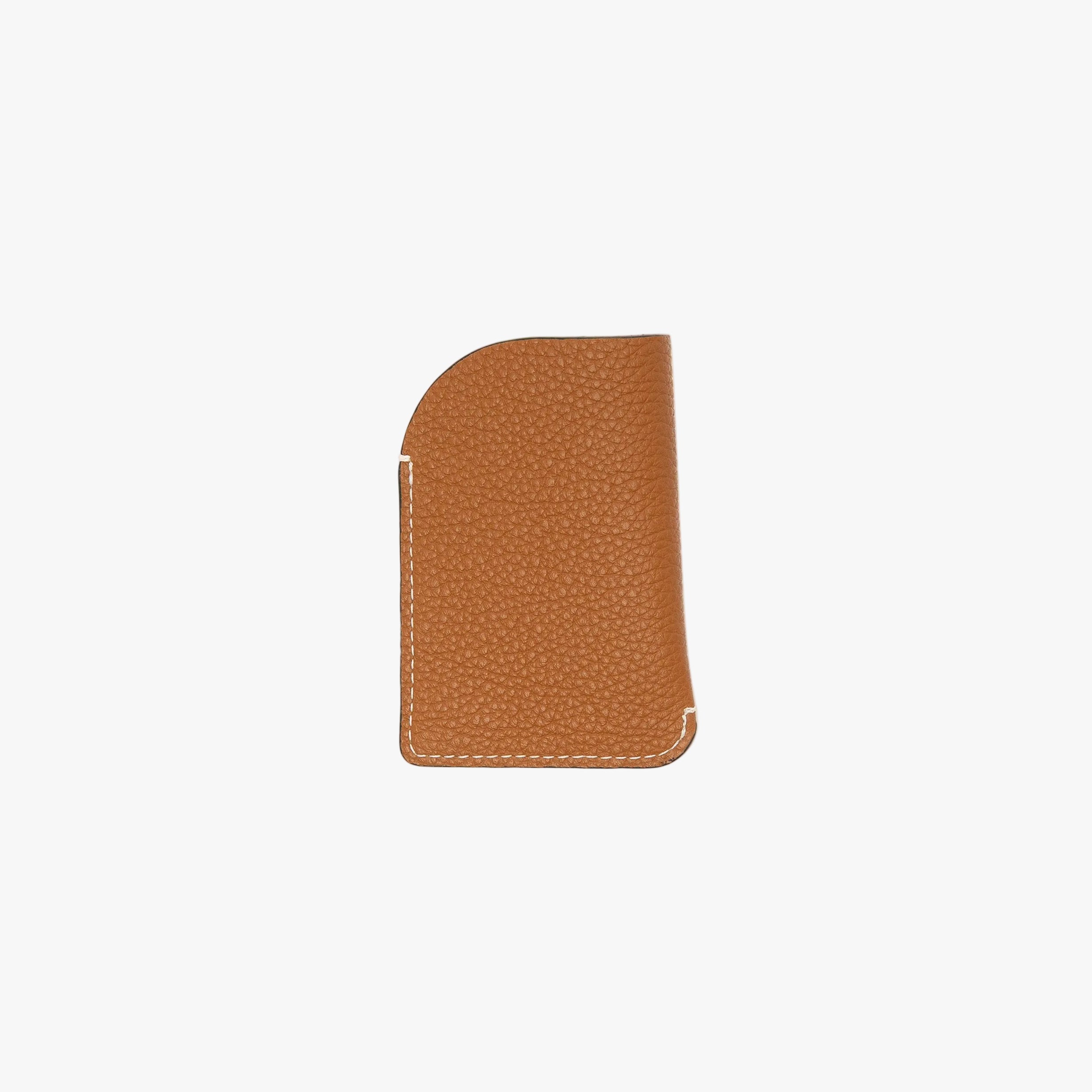 Back panel of STOW London's Mini Cardholder in Mocha pebbled leather on a light grey background