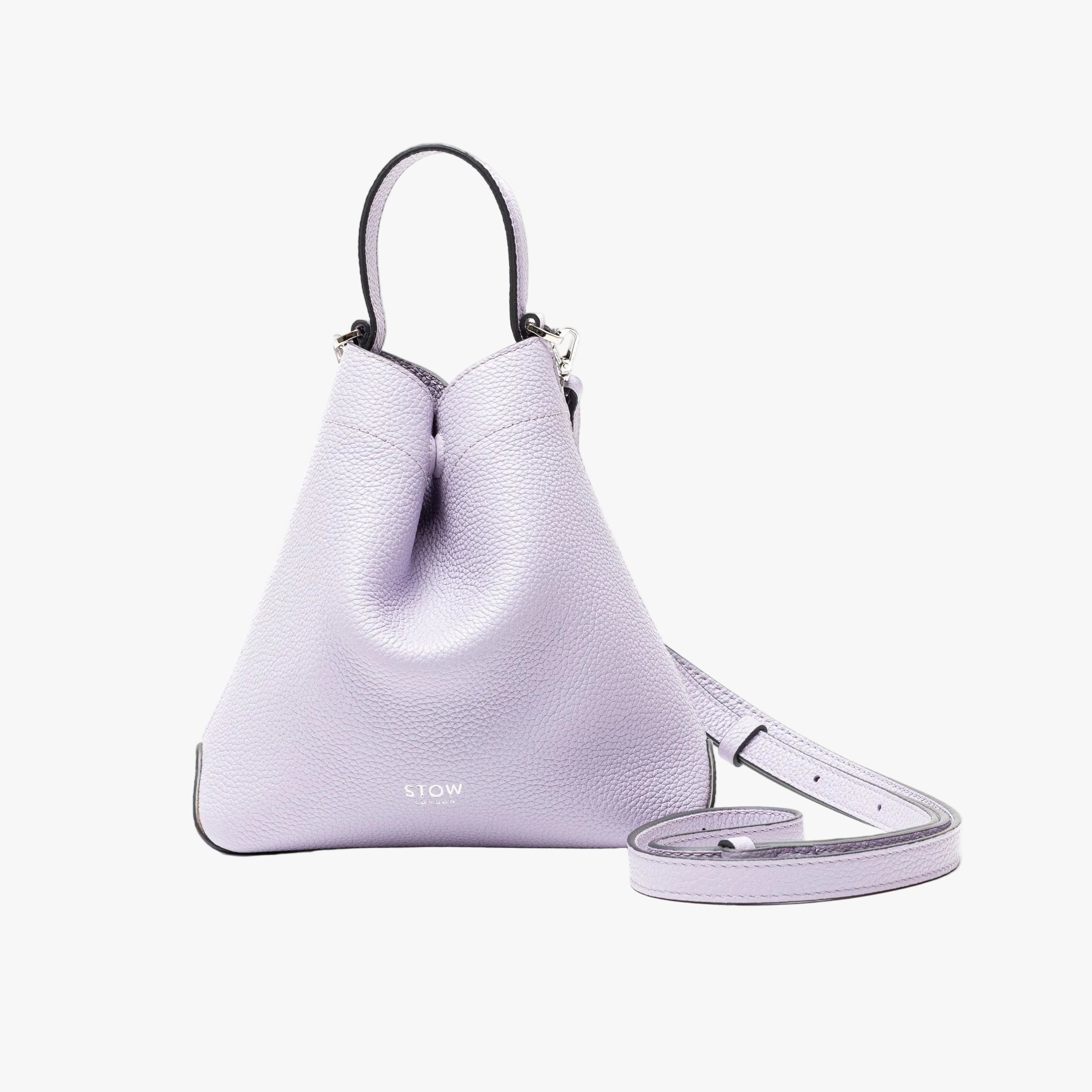 STOW London's Mini Curve Bag and crossbody strap in Lavender pebbled leather on a light grey background