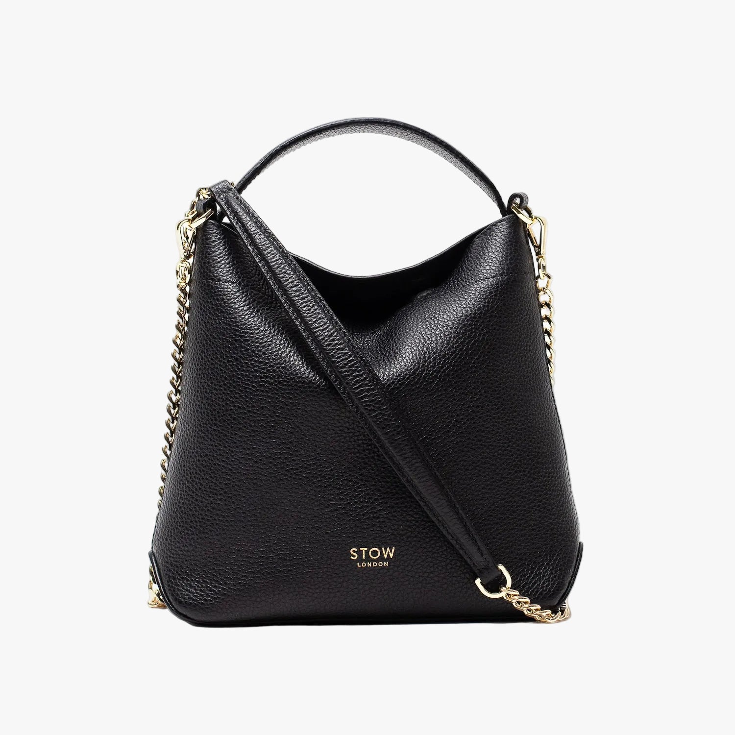 STOW London's Mini Curve in Black pebbled leather and detachable gold chain crossbody strap styled asa flap bag on a light grey background