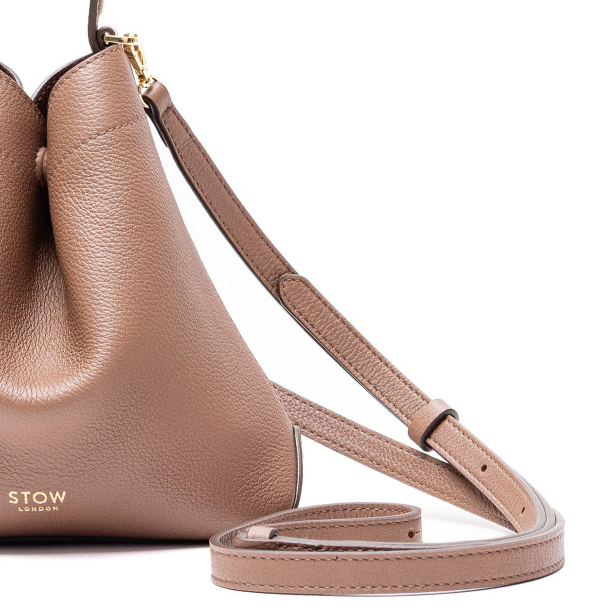 STOW London's Mini Curve in Mocha pebbled and smooth leather with detachable leather crossbody strap featuring gold-coated stainless steel hardware on a white background