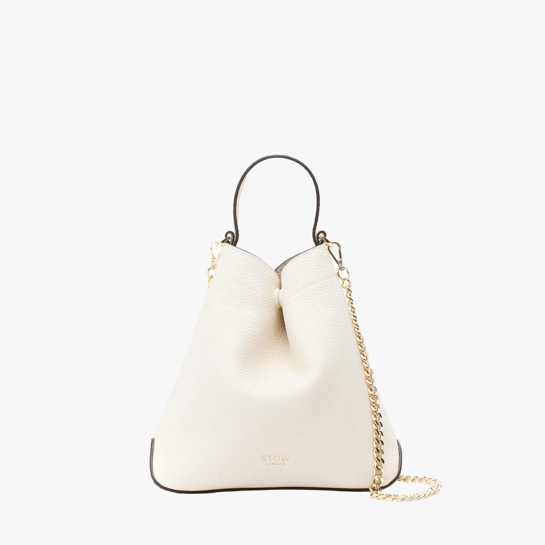 STOW London's Mini Curve in Spring Moon pebbled leather and detachable gold chain crossbody strap styled as a flap bag on a light grey background