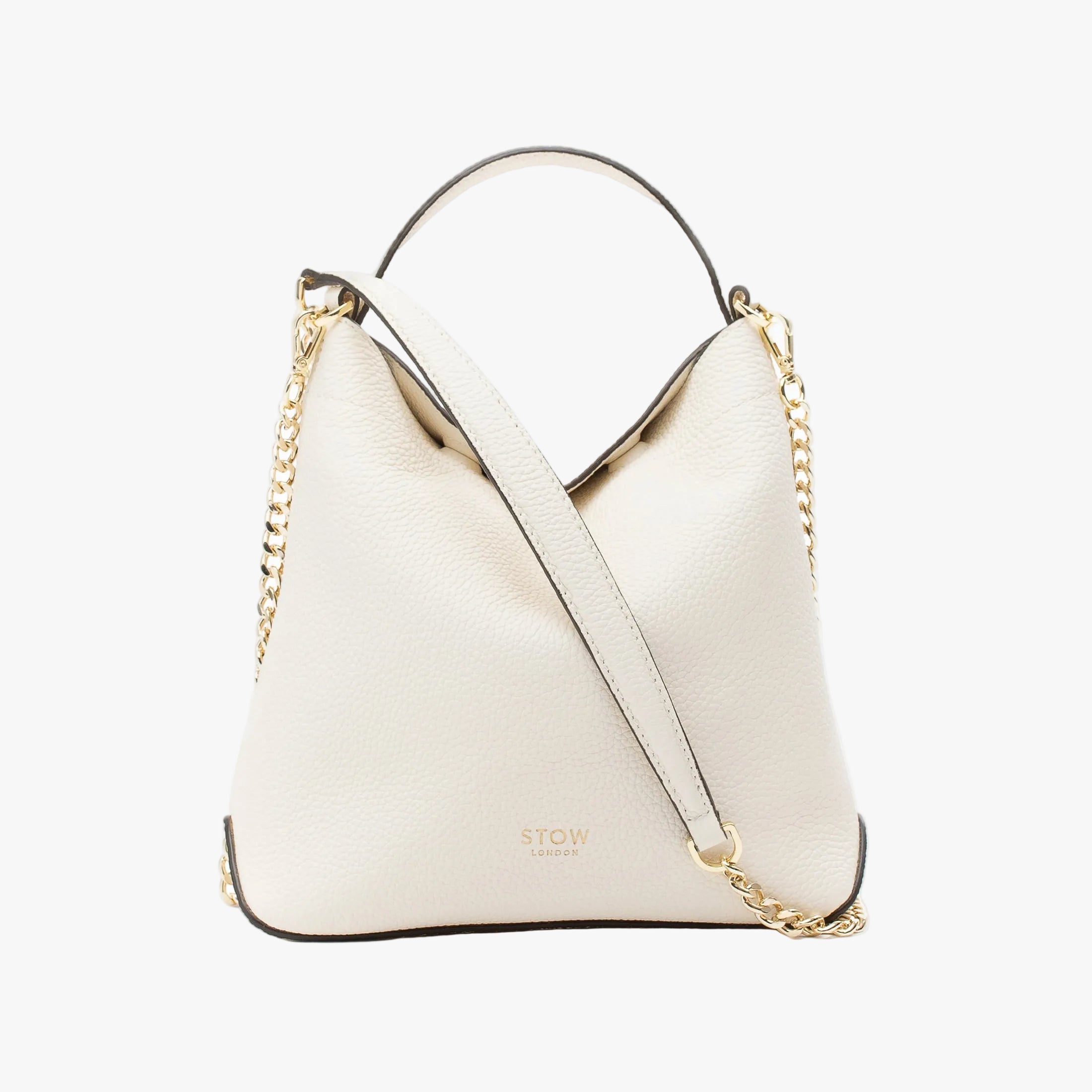 STOW London's Mini Curve in Spring Moon pebbled leather and detachable gold chain crossbody strap on a light grey background
