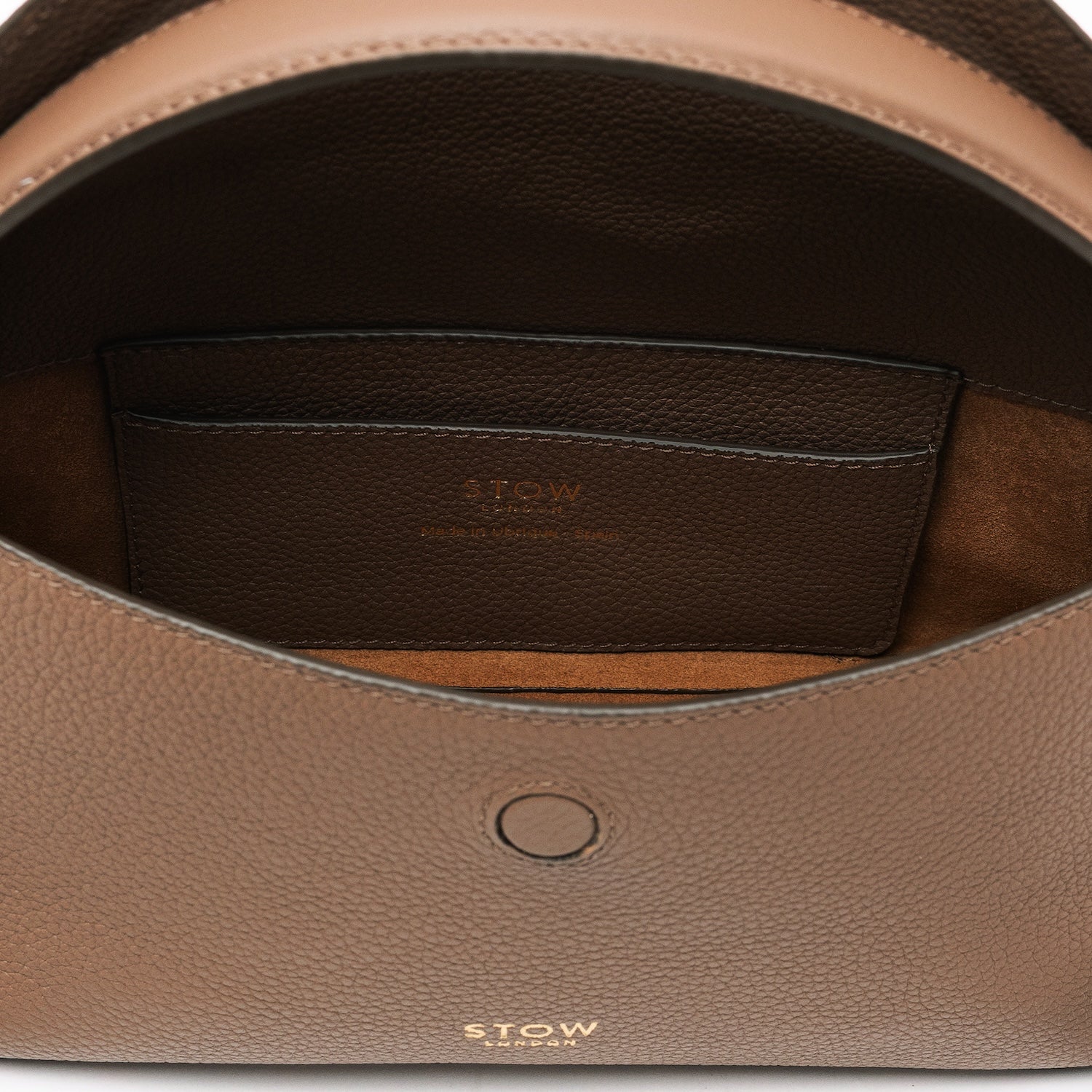 Close up of the interior of STOW London's Mini East West in Mocha pebbled leather featuring suede lining and leather slip pocket