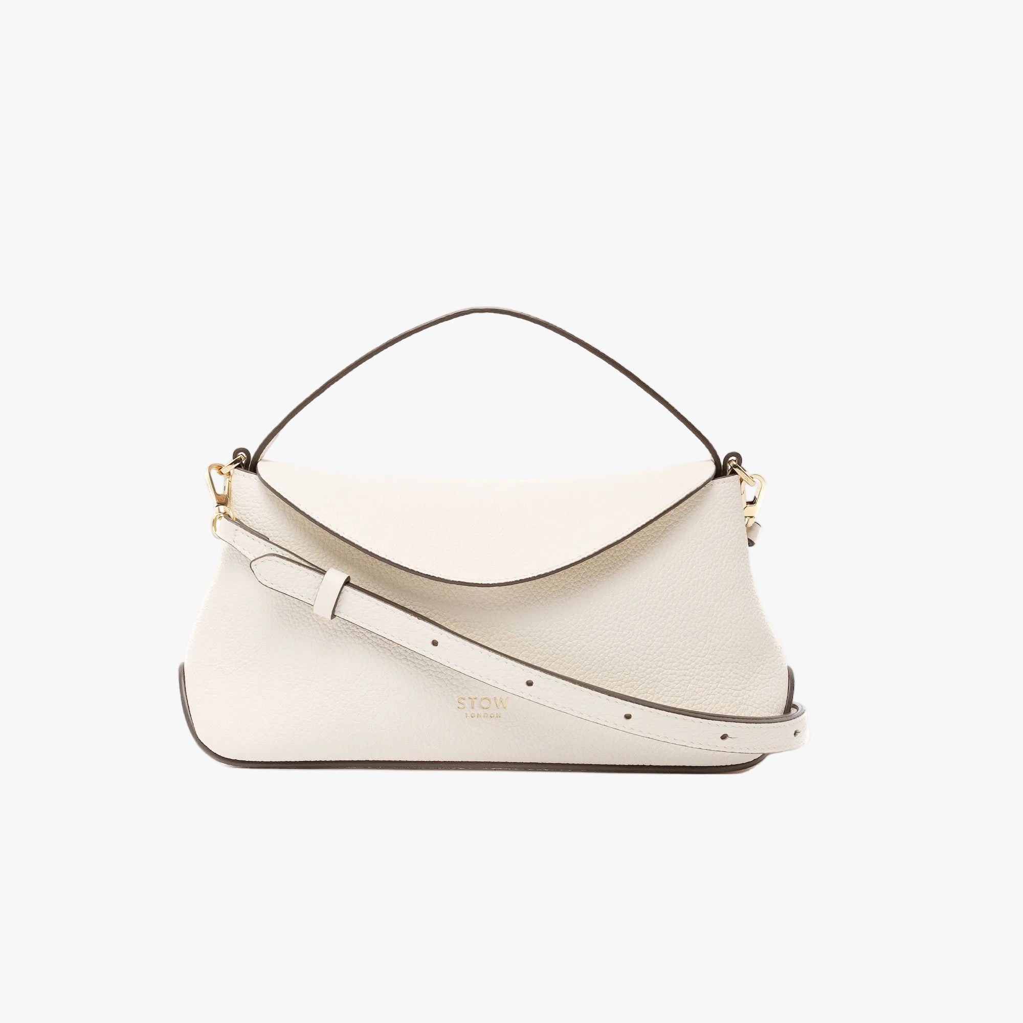 STOW London's Mini East West in Spring Moon pebbled leather featuring its crossbody strap and gold-coated stainless steel hardware on a light grey background