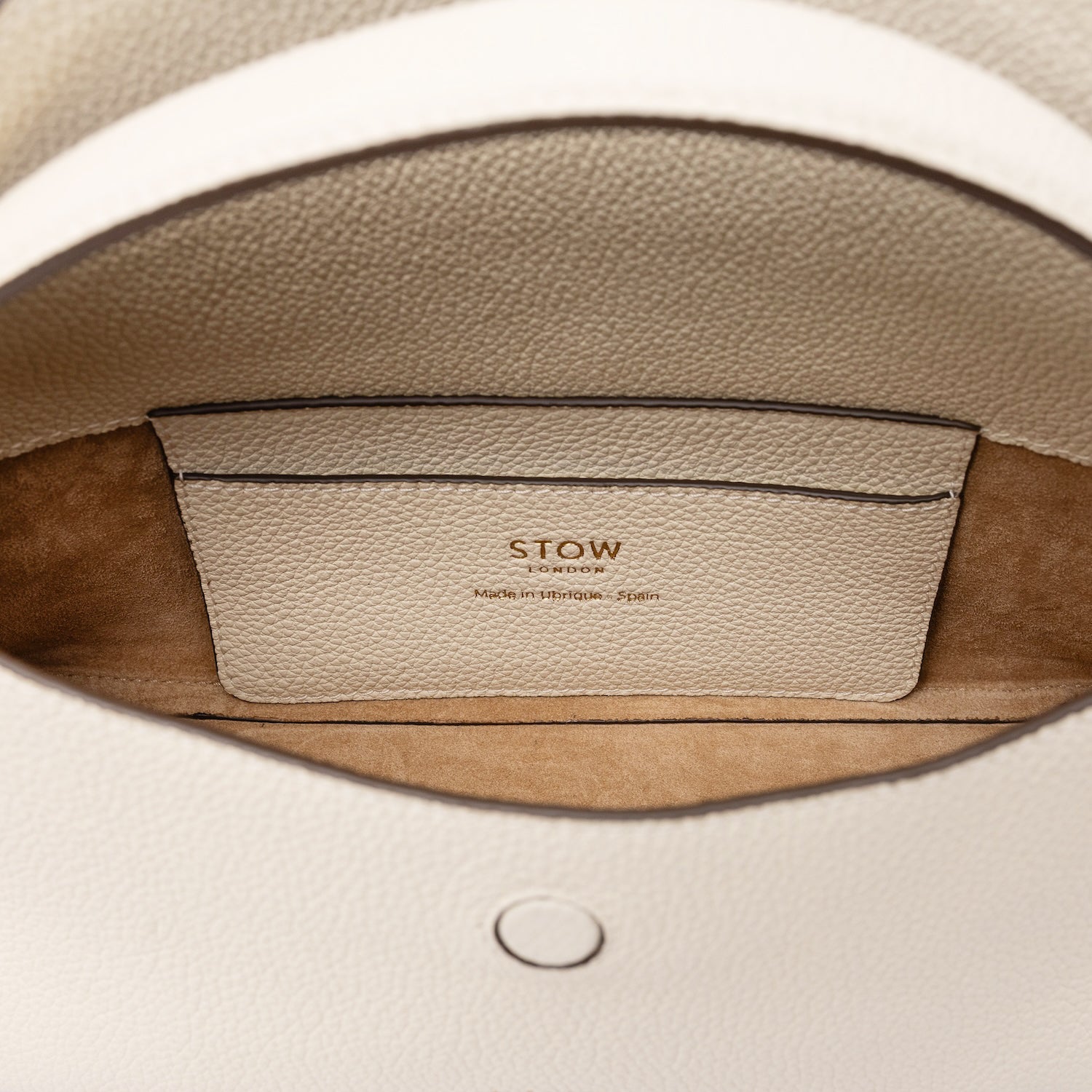 Close up of the interior of STOW London's Mini East West in Spring Moon pebbled leather featuring the suede interior lining and leather slip pocket