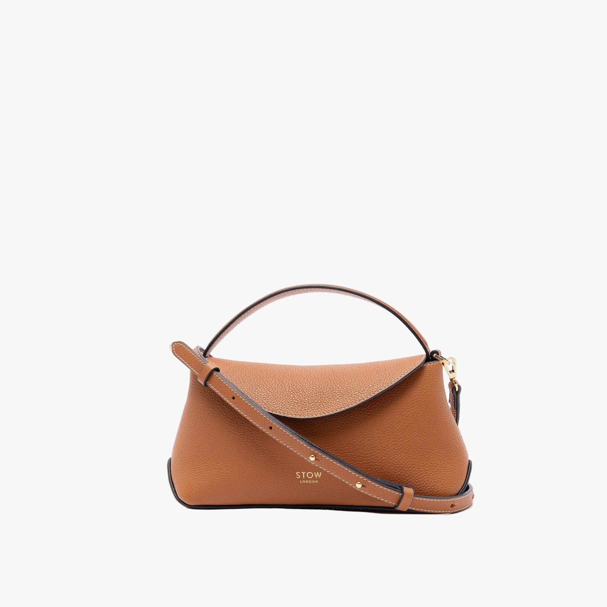 STOW London's Mini East West in Earth Tan pebbled leather and detachable crossbody strap featuring gold-coated stainless steel hardware on a light grey background