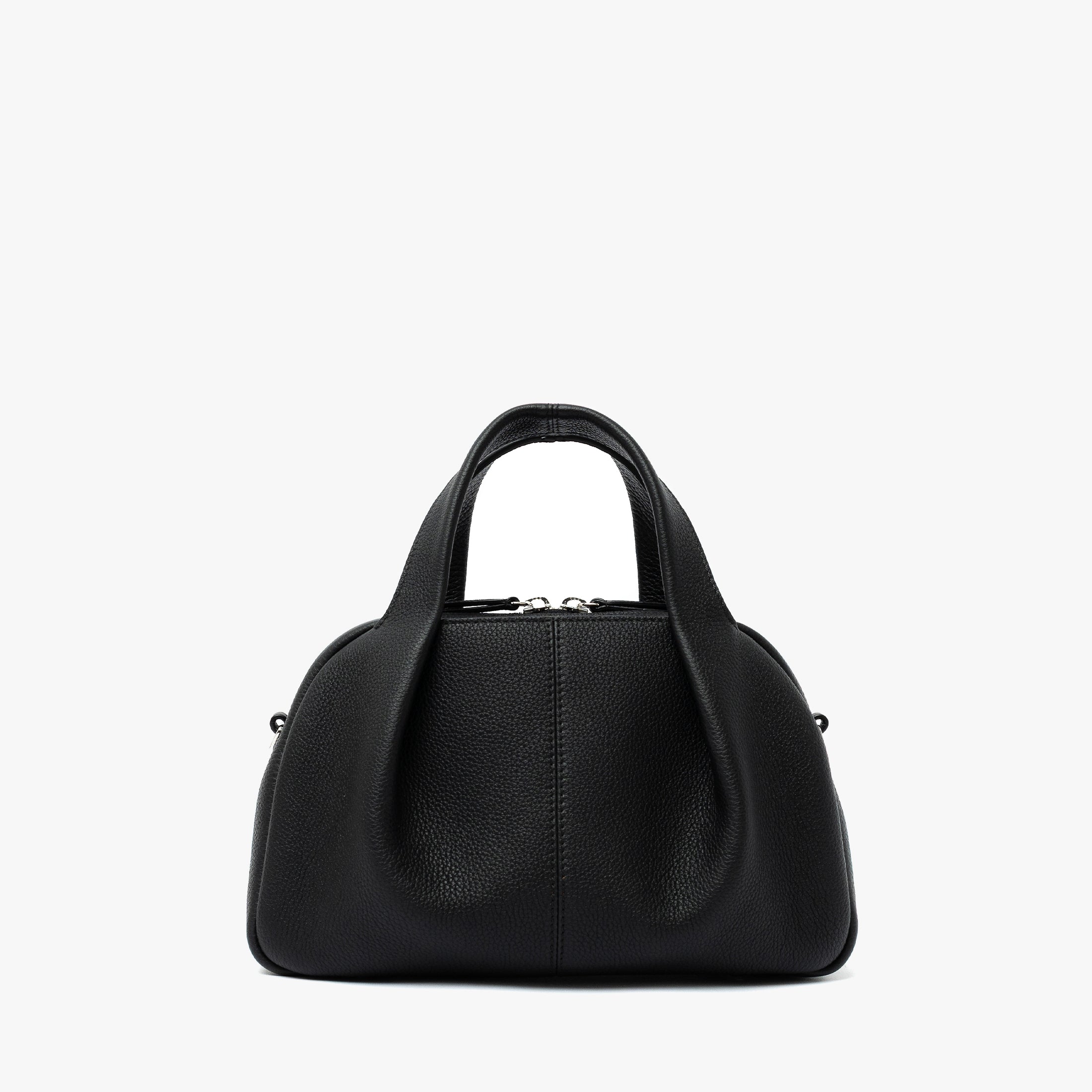 STOW London's Mini Bowling bag in Black pebbled leather featuring a pleated front panel and silver stainless steel hardware on a light grey background