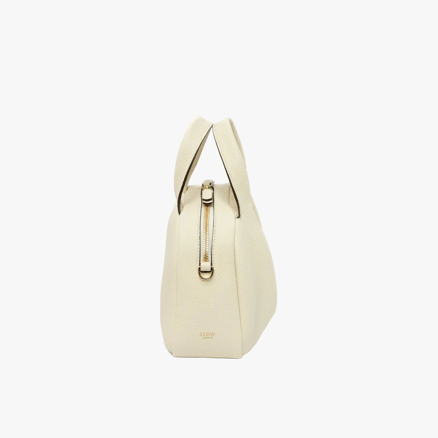 Side view of STOW London's Mini Bowling bag in Spring Moon pebbled leather featuring the zip closure and small gold logo on a light grey background