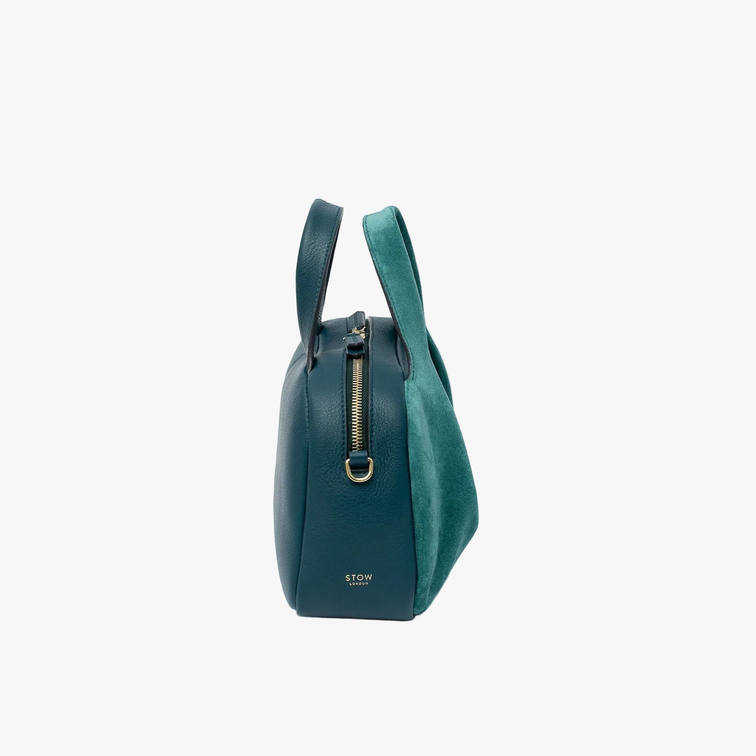 Side view of STOW London's Mini Bowling bag in Ocean Teal suede and smooth leather featuring a pleated front panel, gold-coated stainless steel hardware and small gold logo on a light grey background