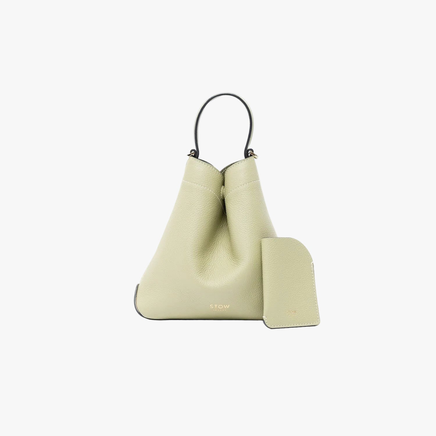 STOW London's Mini Cardholder in Pale Green pebbled leather alongside the matching Mini Curve bag on a light grey background featuring a small gold embossed logo on both front panels