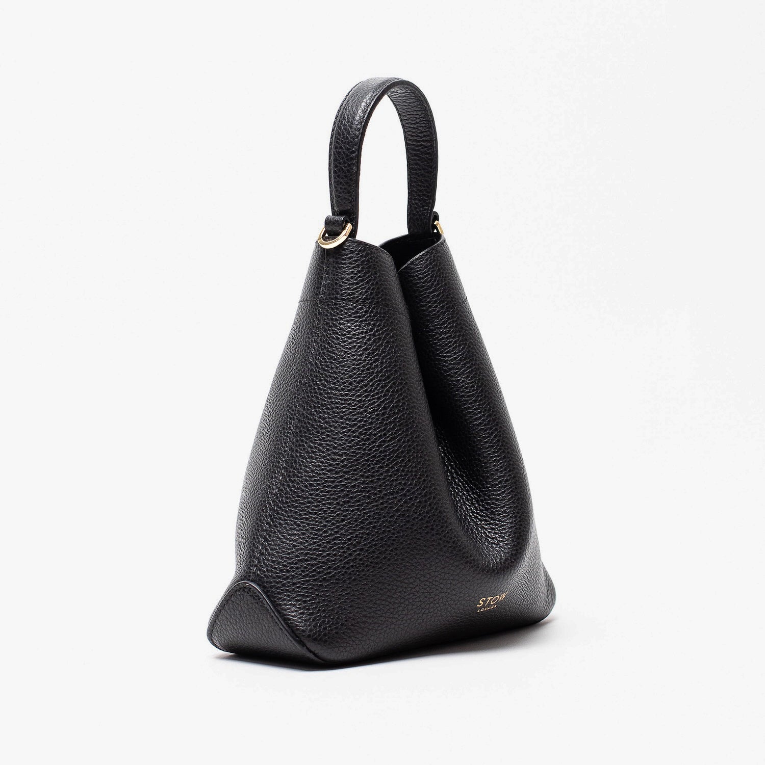 Off-axis view of STOW London's Mini Curve in Black pebbled leather featuring gold details on a light grey background